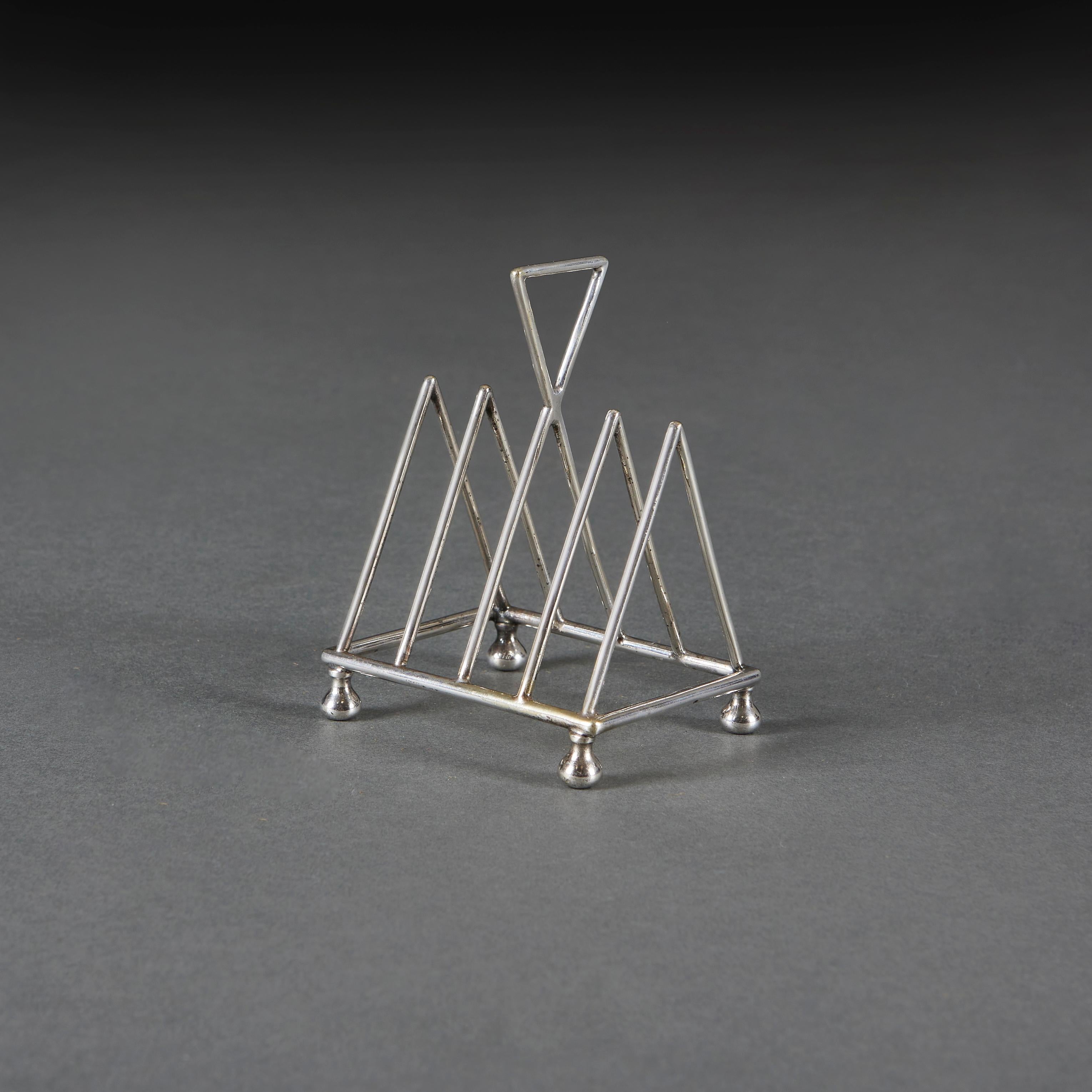 English A Group of Three Christopher Dresser Toast Racks