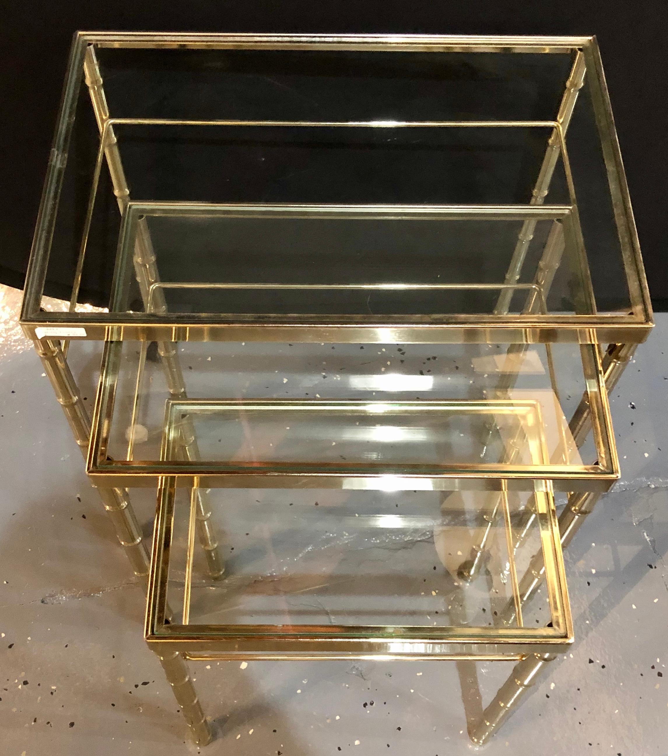 A group of three faux bamboo brass nesting tables with glass tops. These tables represent Asian and Postmodern design.

LX.