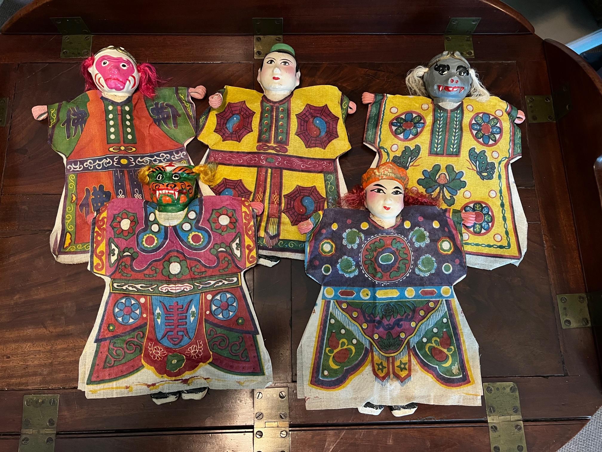 An interesting collection of five (5) unused, vintage Chinese puppets.