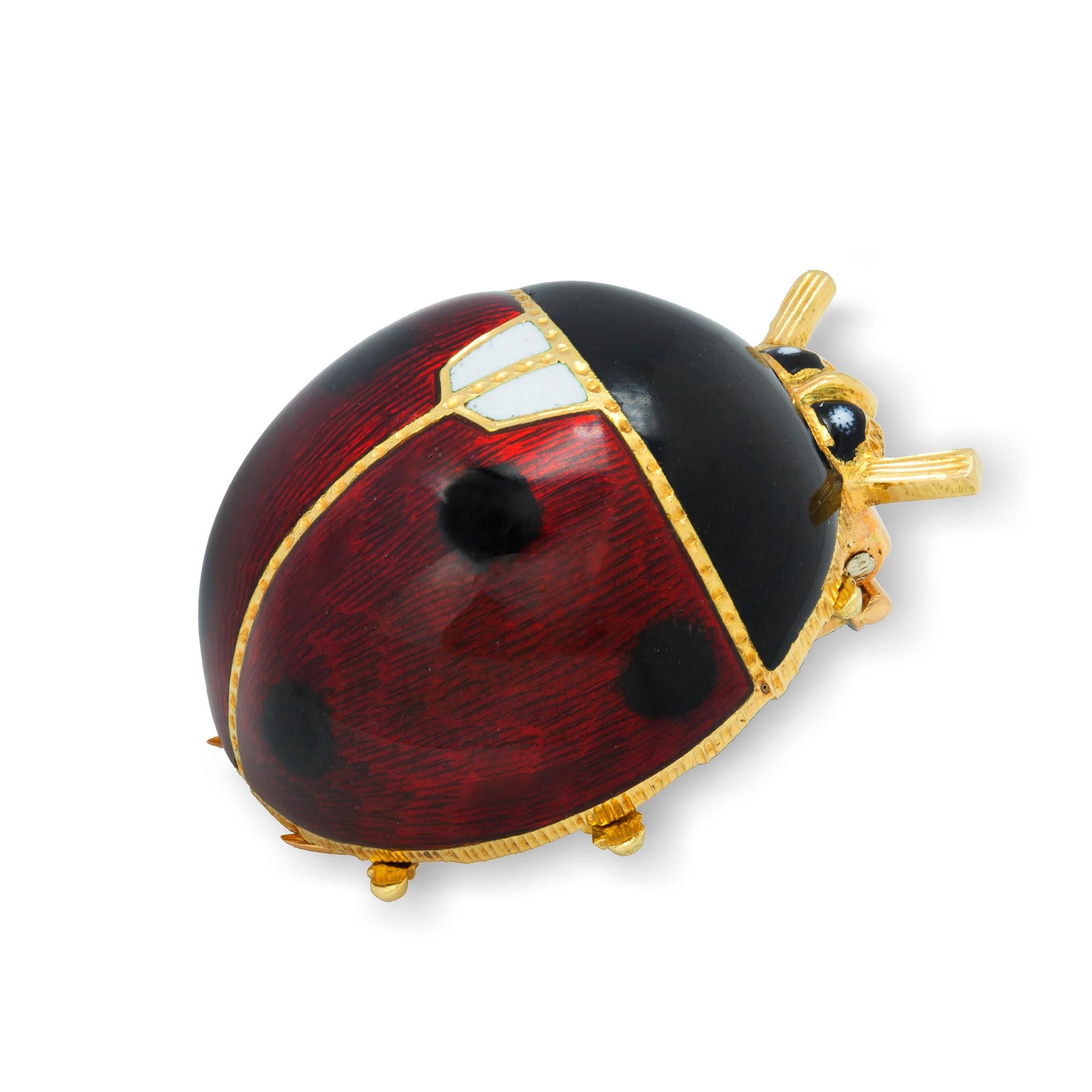 A guilloché enamel ladybird brooch, the red, black and white enamelled body, all to a yellow gold mount with pin brooch fitting, marked 18ct gold, Italy, circa 1960s, measuring approximately 2.7 cm in diameter, gross weight 18.00 grams.

Ladybird