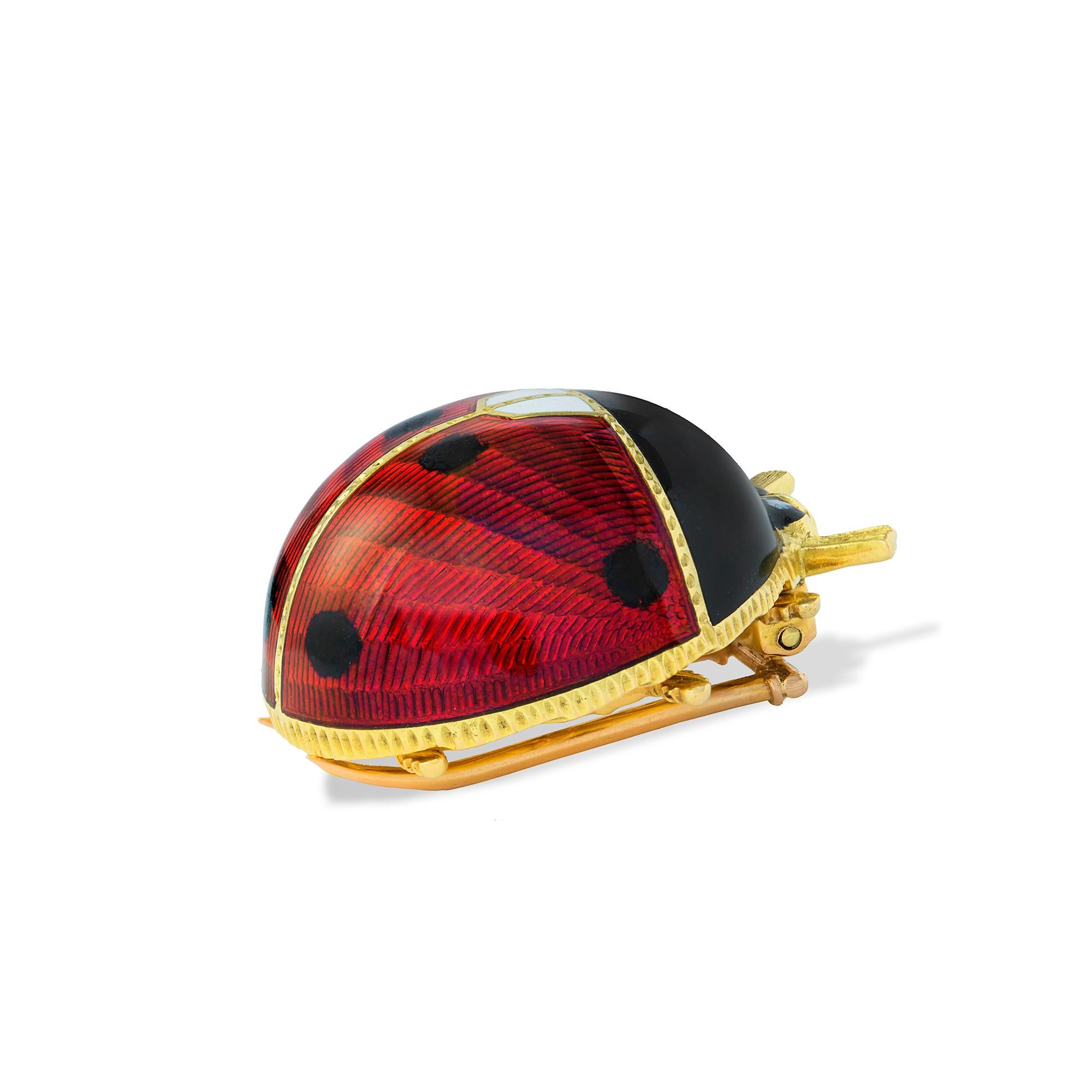 A guilloché enamel ladybird brooch, the red, black and white enamelled body, all to a yellow gold mount with pin brooch fitting, marked 18ct gold, Italy, circa 1960, measuring approximately 2.7 cm in diameter gross weight 18.00 grams.

This brooch