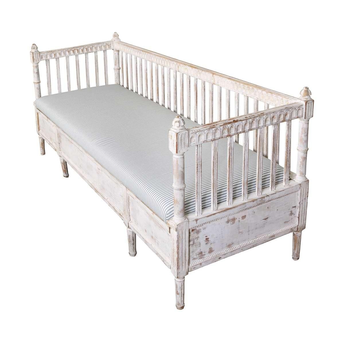 This elegant bench reflects the refined simplicity of the Gustavian style, with its spindle back, fluted legs, and worn whitewashed finish. Upholstered in a classic pinstripe fabric, it adds timeless Scandinavian charm to any entryway, hallway, or