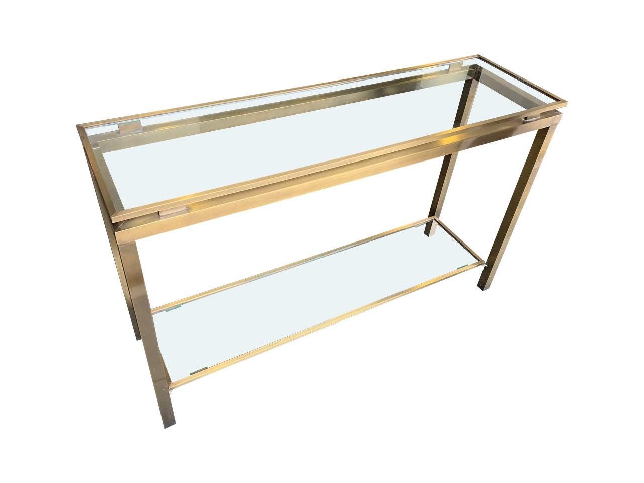 A Guy Lefevre style gilt metal console with signature floating top with glass and a lower shelf.
   