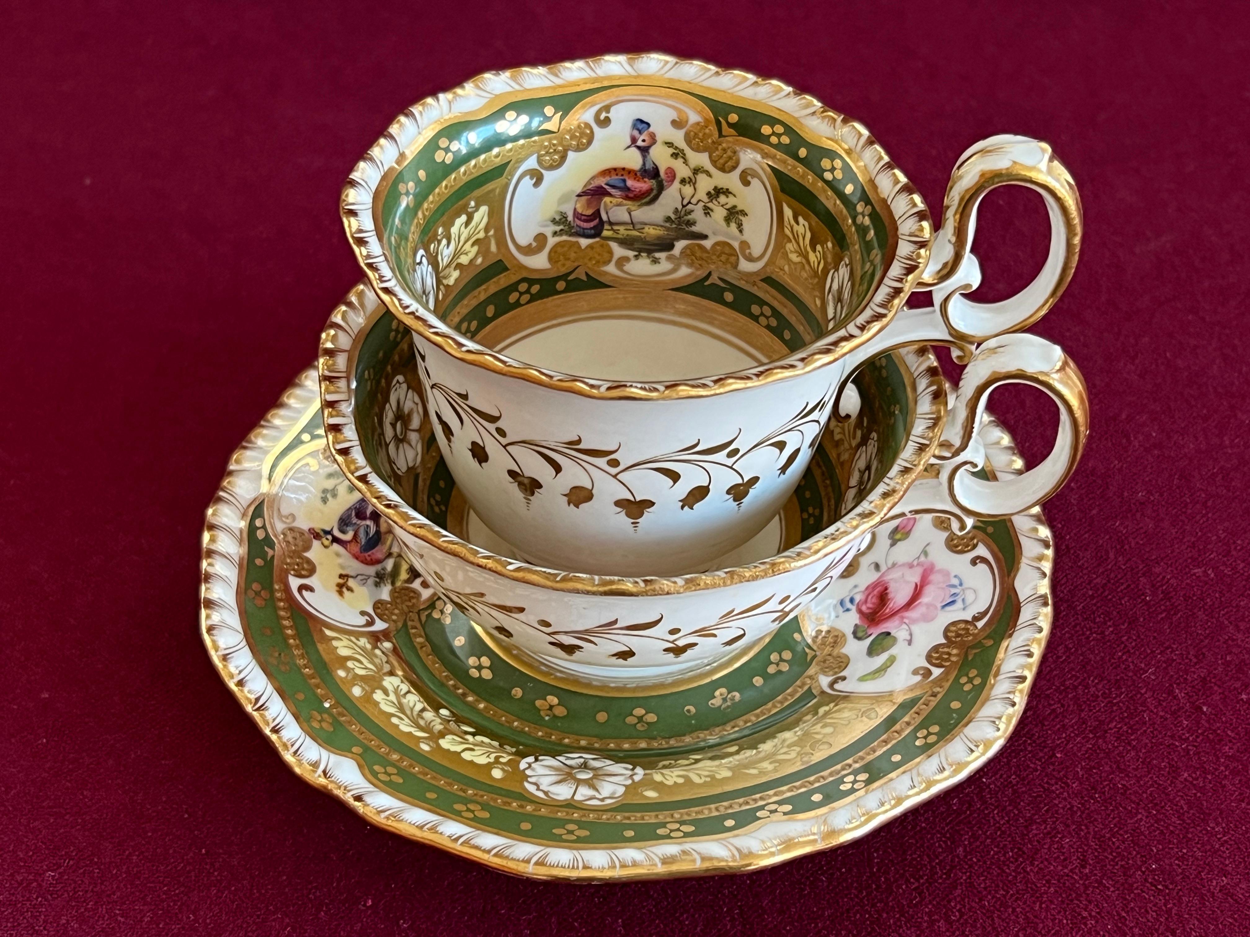 A superb and rare H & R Daniel porcelain trio of Second Gadroon shape c.1825. Each piece finely decorated in pattern 4069 with a rich green ground, panels containing alternate birds and flowers, gilt oak leaves and acorns, reserved white flowers and