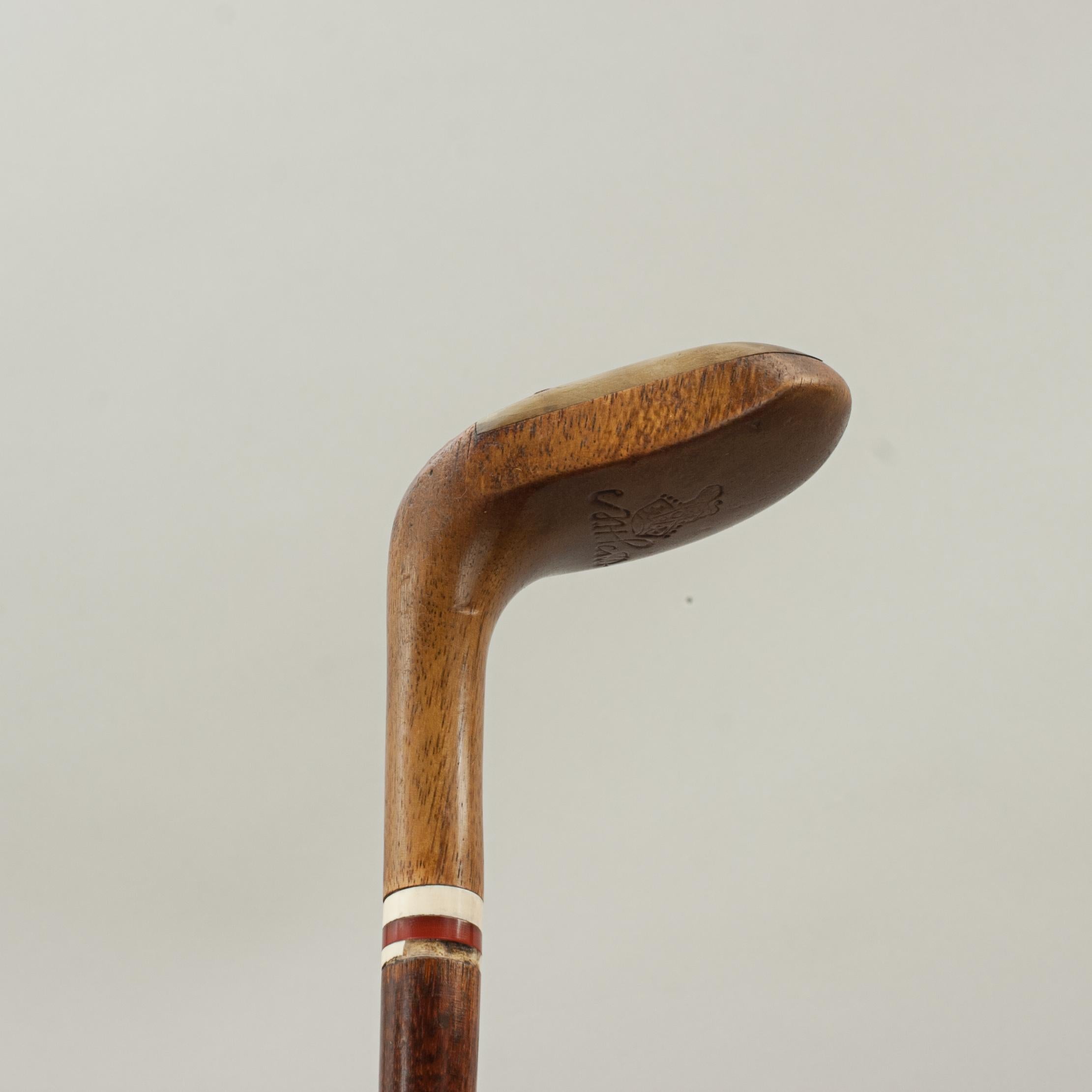 Antique Sunday Club, Golf Club Walking Stick By A.H. Scott.
A desirable walking cane with the handle in the shape of a golf club head. The gentleman's walking stick has a persimmon socket head handle with a pegged horn insert and a lead weight to