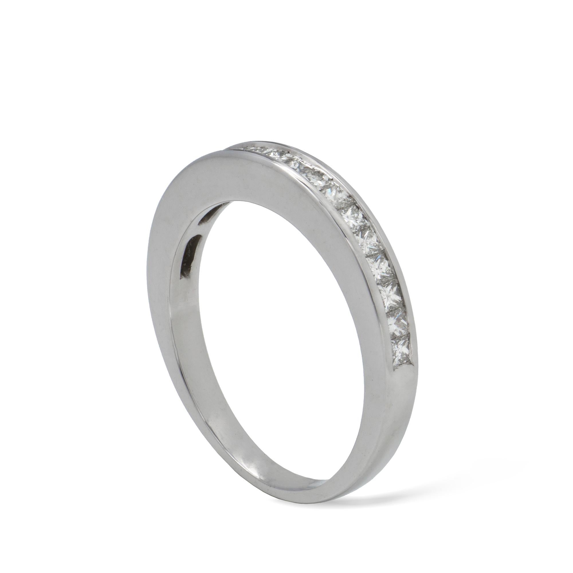 A half eternity diamond ring, the nineteen princess-cut diamonds with total estimated weight 0.50 carats, channel-set in a white gold mount, hallmarked 18ct gold London, bearing the Bentley & Skinner sponsor-mark, meassuring 2.6mm wide, finger size