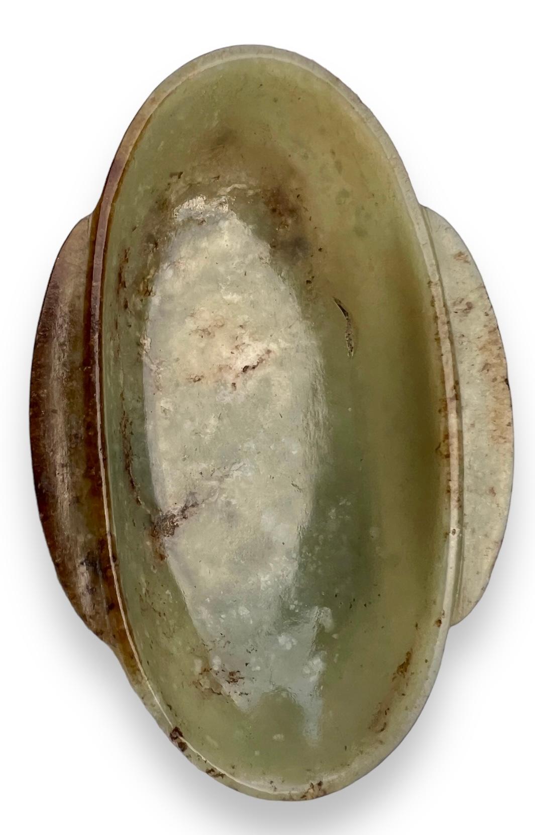 A Han-style celadon and russet jade ear-cup, Qing dynasty. 7