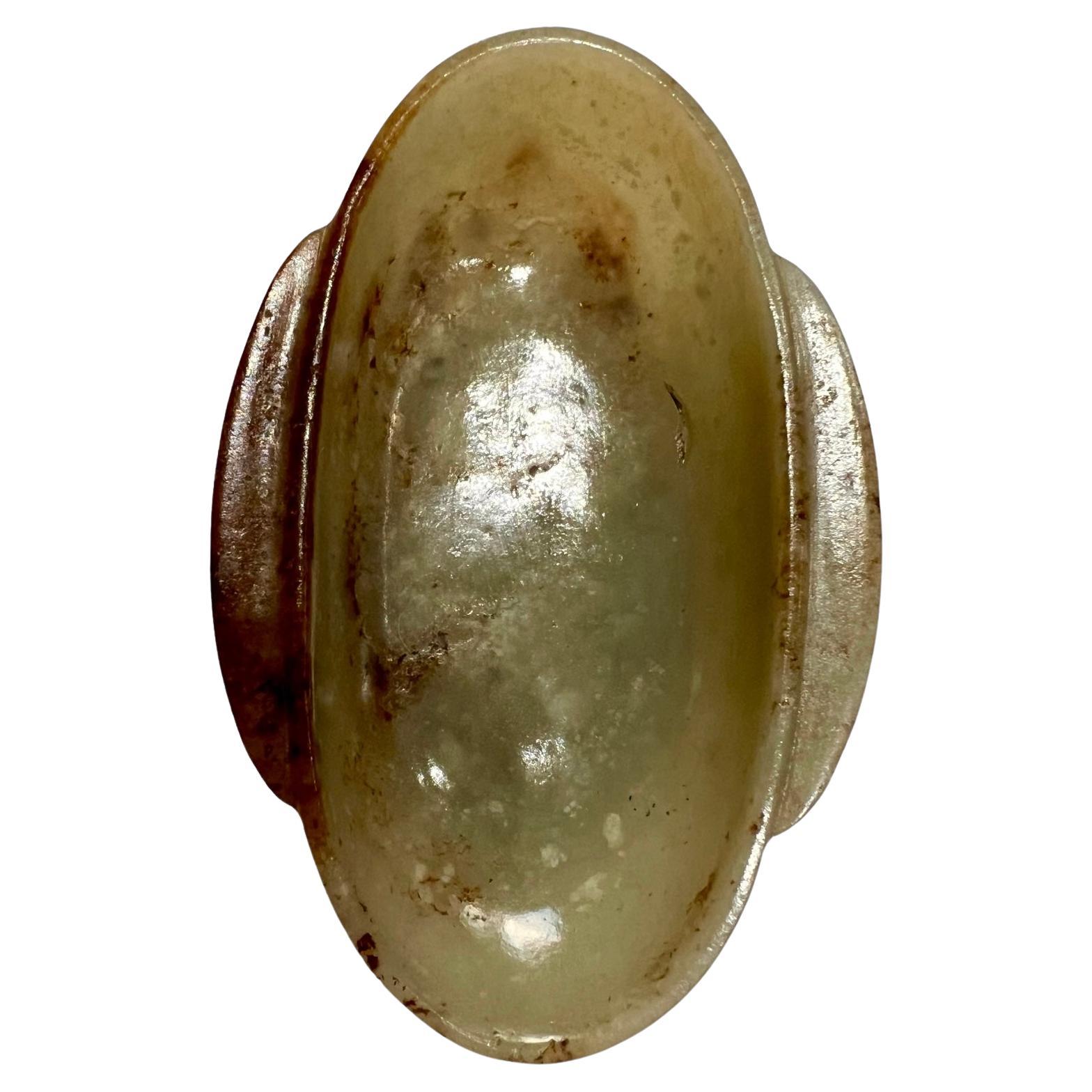 A Han-style celadon and russet jade ear-cup, Qing dynasty.