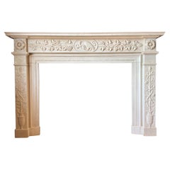 A hand carved English Regency style white statuary marble fireplace mantel