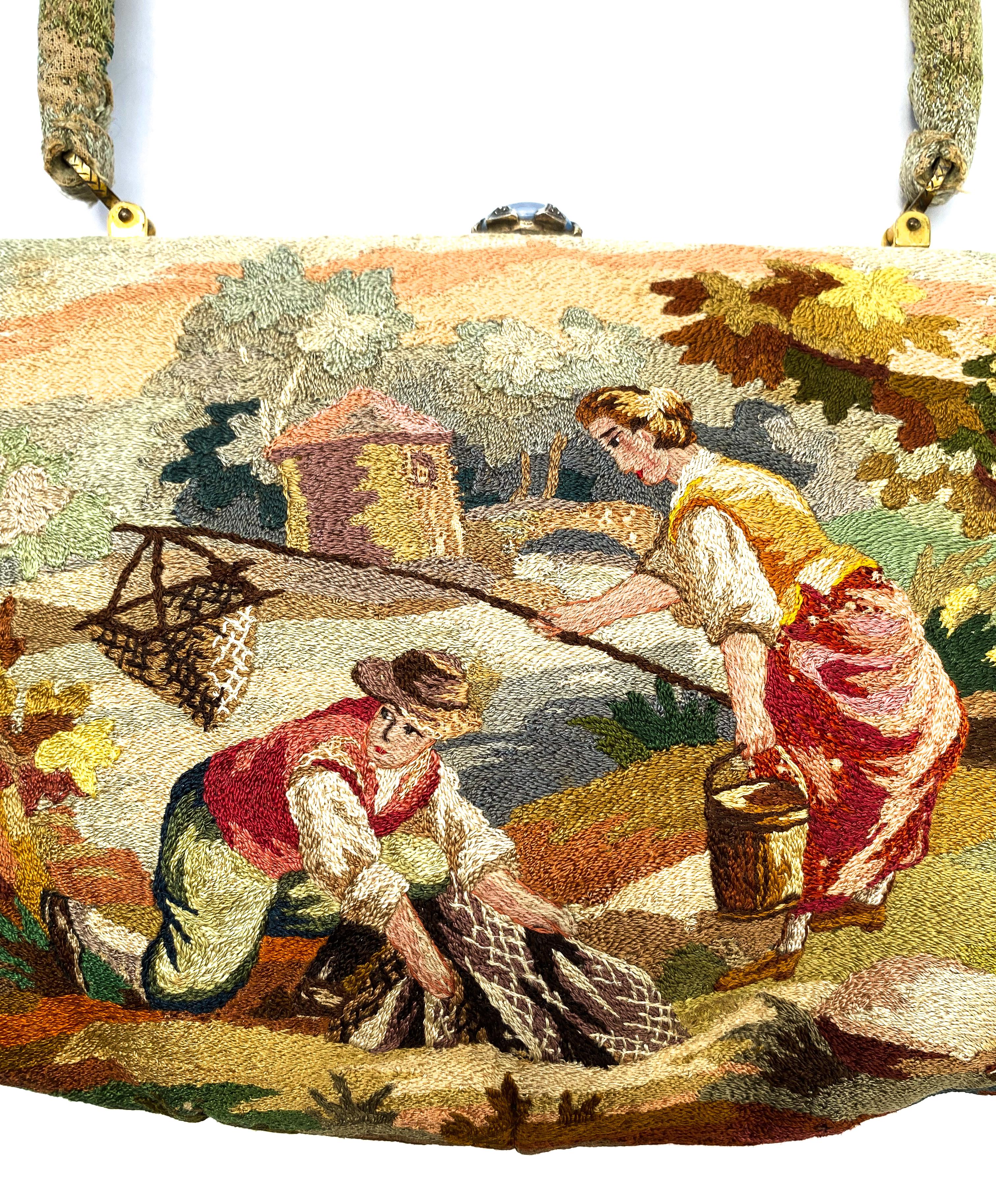 A beautifully hand stitched and sewn handbag with a charming antique rustic scene with two figures by master craftsmen and luxury good manufacturer Morabito. executed in silk, in fine and varied stitching, some in slight relief, and some in delicate