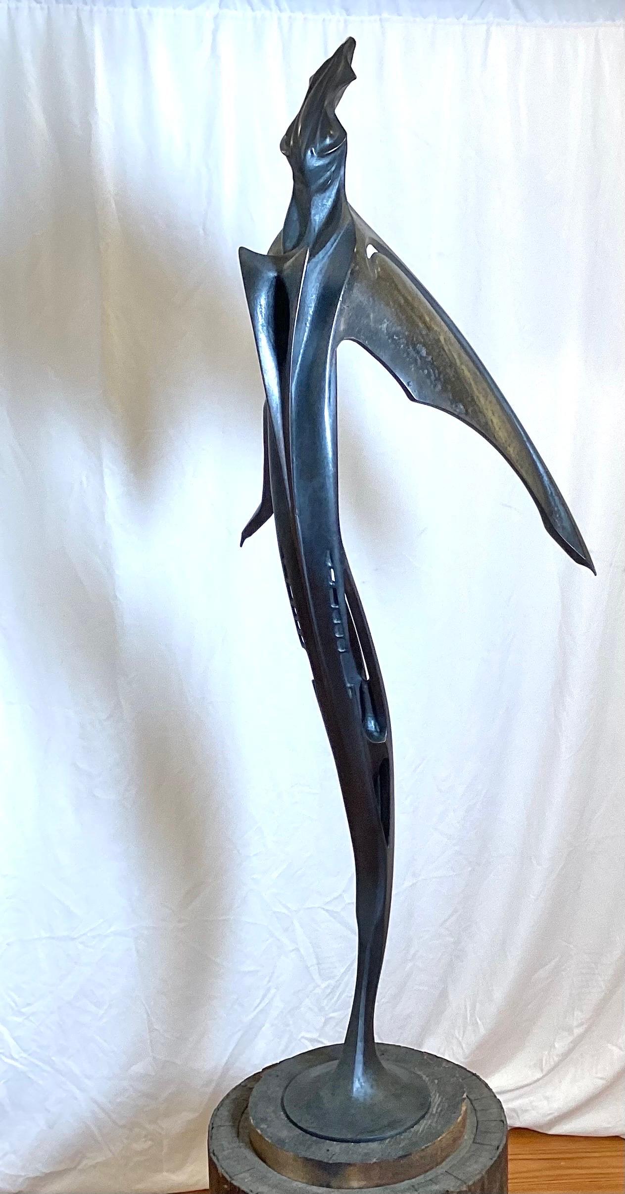 Tis is a one of a kind tall, slender sculpture in patinated bronze by Lawrence Welker IV.  It rotates on the base to allow it to be viewed from all sides.  51 Inches Tall, Signed near the base. 

Lawrence Welker IV was  raised  in the creative and