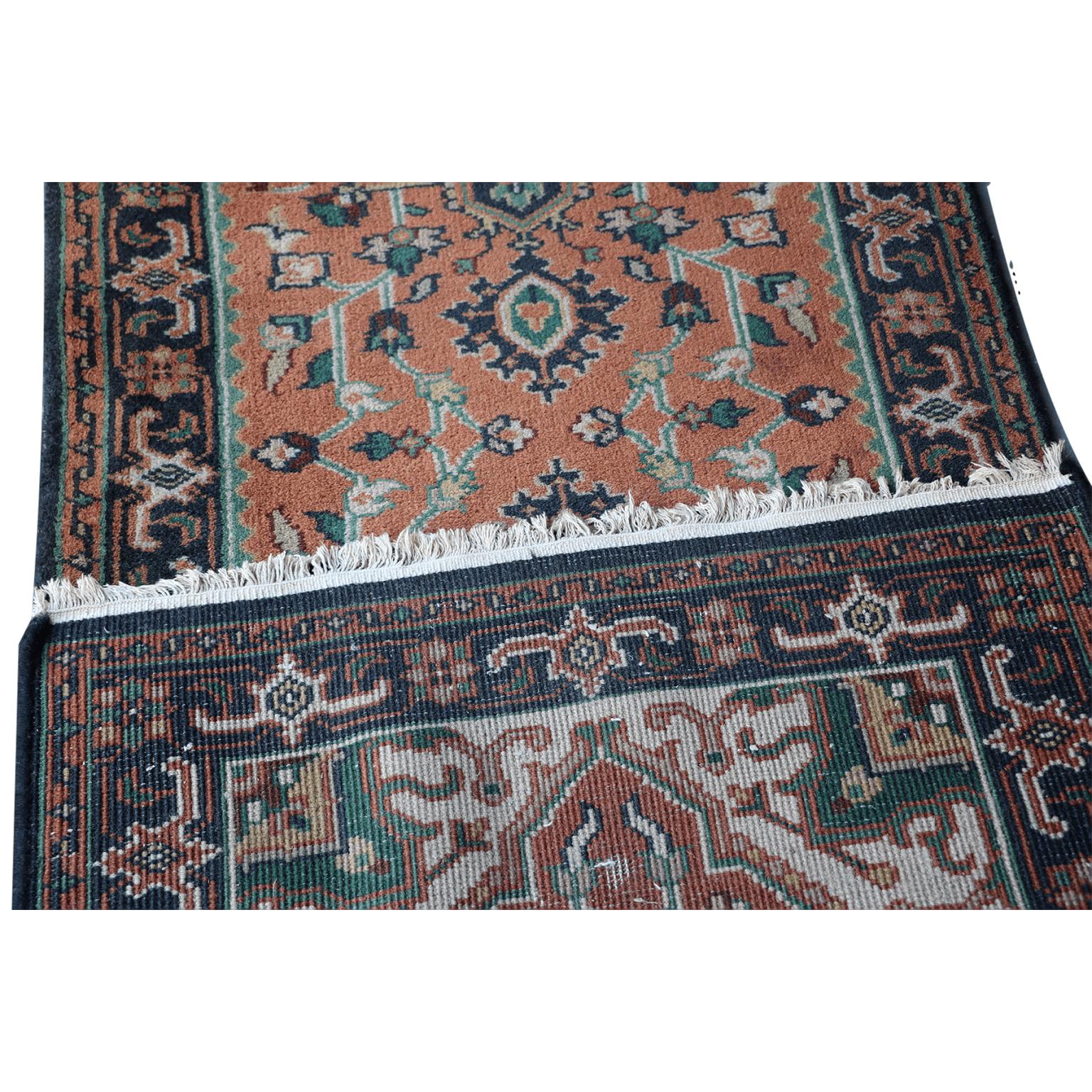 A very fine hand knotted Indo Heriz runner, North India, wool on cotton foundation

The terracotta field with two blue stepped medallions, supported by angular flowering vines, within a blue turtle palmette and angular vine border. 

Extra