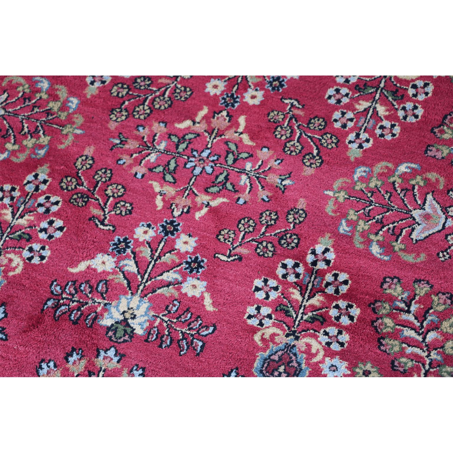 The rose red field with a central skeletal floral medallion radiating flowering plants, within a blue palmette and vine border. A very fine hand knotted Indo Sarough wool on cotton foundation circular rug, made in North India.
The term Sarough