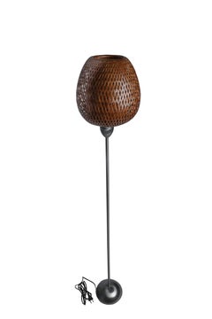 A Hand-Woven Rattan Shade and Chrome Floor Lamp