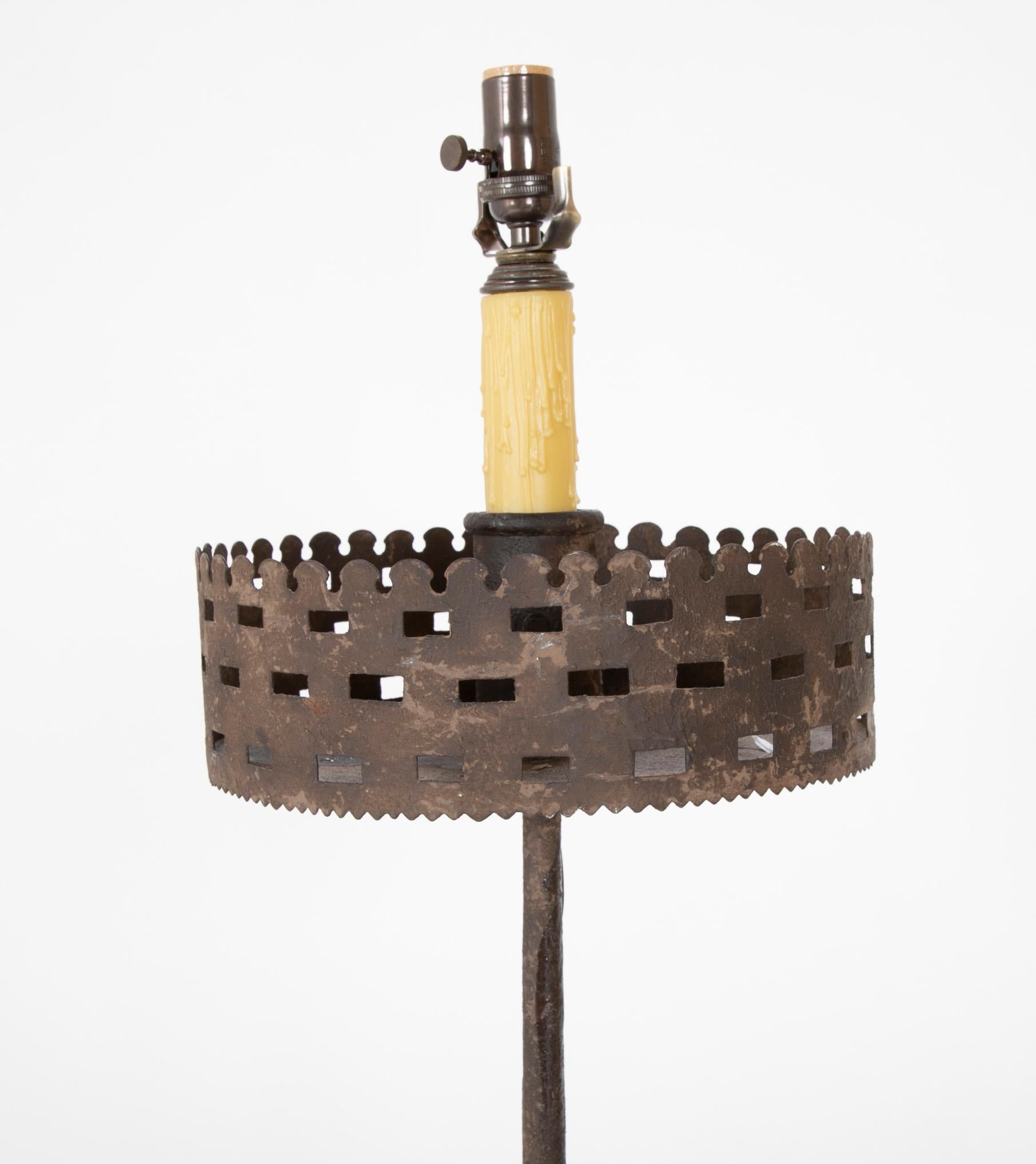 A crenalated pricket stick now updated as a floor lamp.
