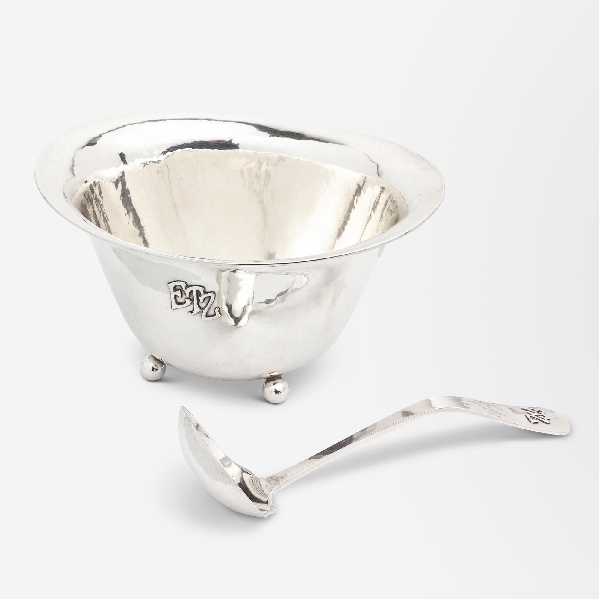 There is something very charming about this footed oval bowl and matched sterling serving spoon by Lebolt and Company. The two pieces are hand wrought from sterling silver with the bowl sitting atop of four small silver spheres, while the spoon is