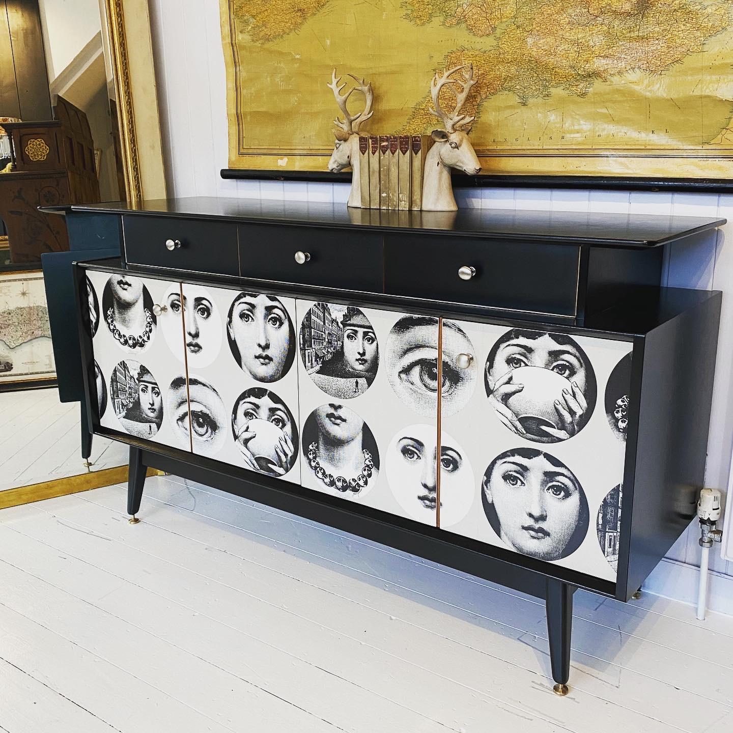 A beautifully made teak sideboard from the 1950s. Creatively decoupaged with a Fornasetti paper that is now discontinued. The sideboard has been restored, sanded and professionally hand sprayed. A wonderfully figured top section holding three