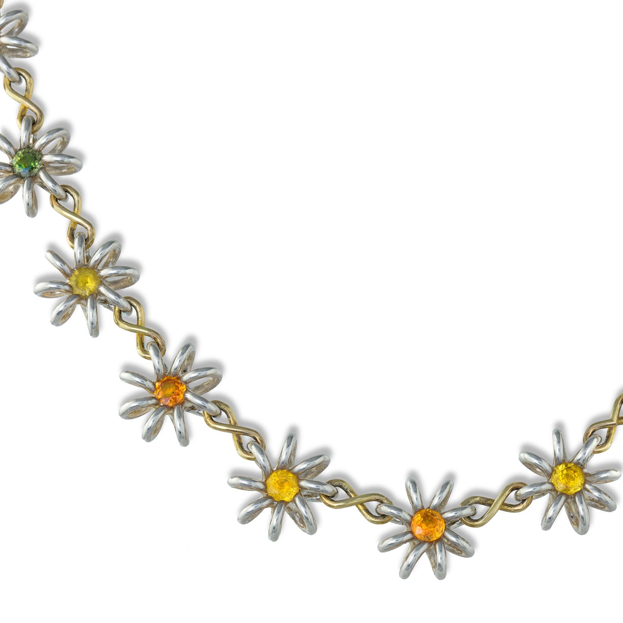 A handmade silver and gold necklace by Lucie Heskett-Brem the Goldweaver of Lucerne, inspired by Darcey Bussell the necklace consisting of twenty-three silver flower-heads each centrally-set with a fancy colour sapphire, the sapphires estimated to