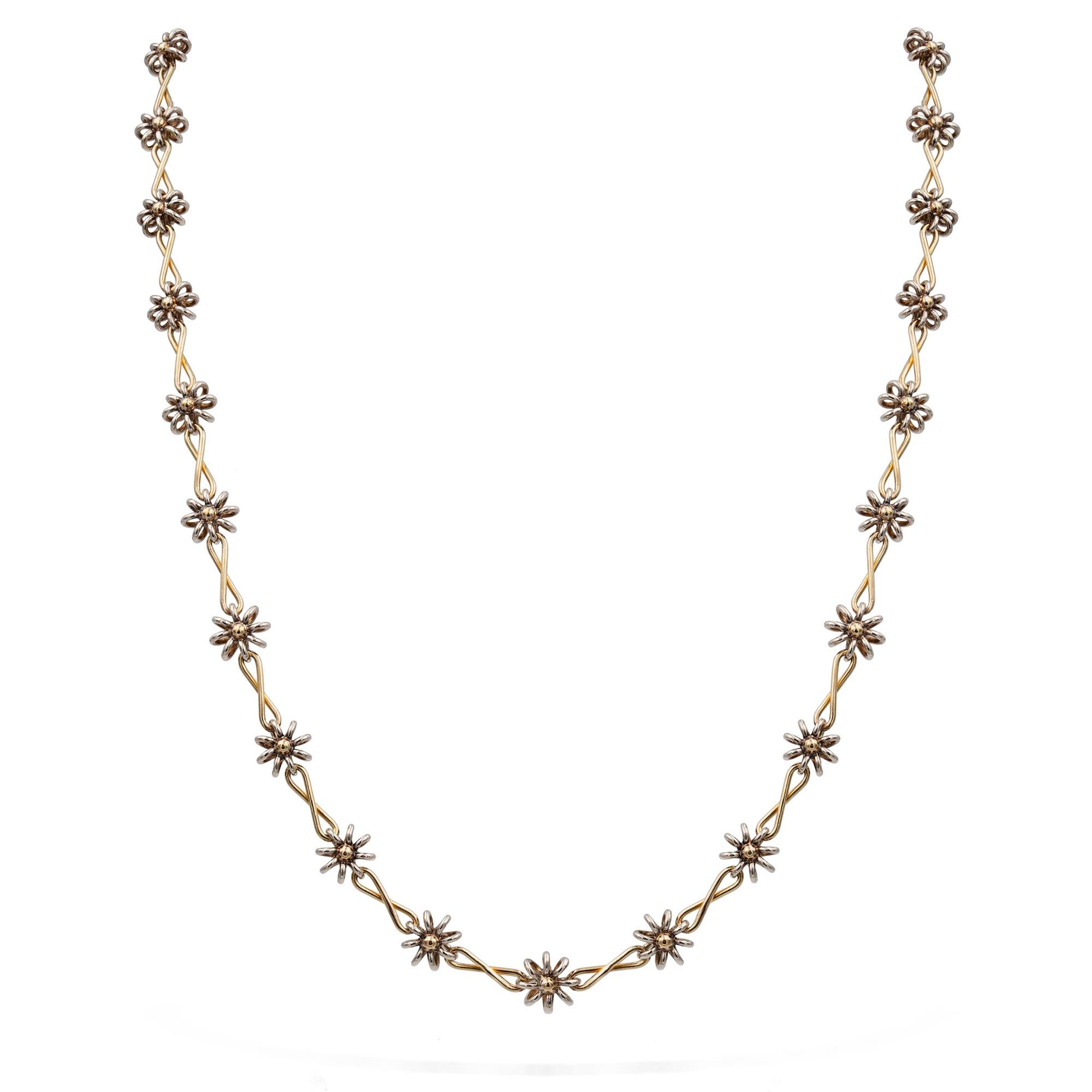 A handmade silver and gold necklace by Lucie Heskett-Brem the Goldweaver of Lucerne, inspired by Darcey Bussell the necklace consisting of thirty-three silver and gold flowerheads, connected with yellow gold links, bearing Swiss silver and gold