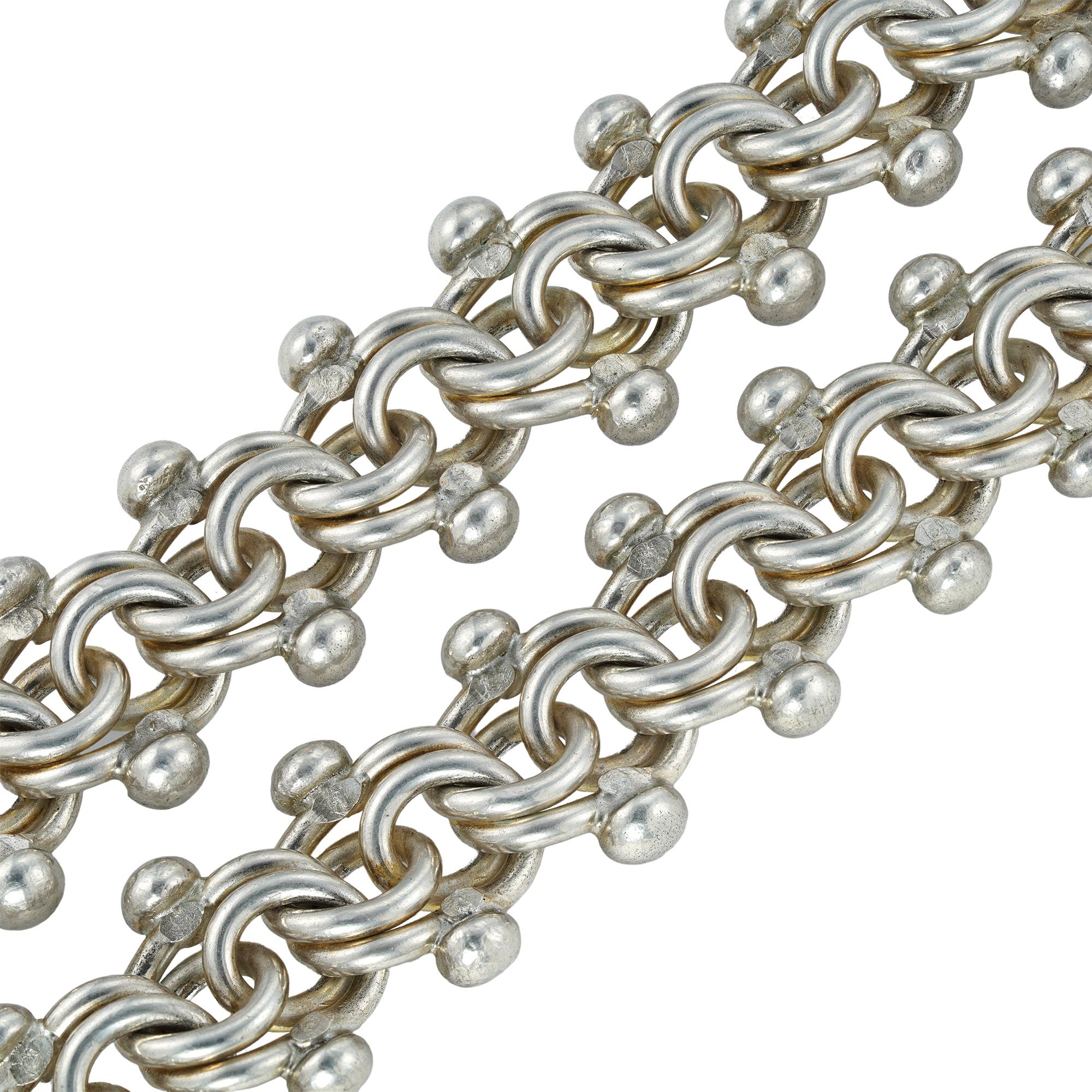 A handmade silver Troubadour chain by Lucie Heskett-Brem the Gold Weaver of Lucerne, consisting of forty interlocking links, made in silver, hallmarked sterling silver, London, 2019, measuring approximately 45 x 1.8cm, gross weight 157.7 grams.

A