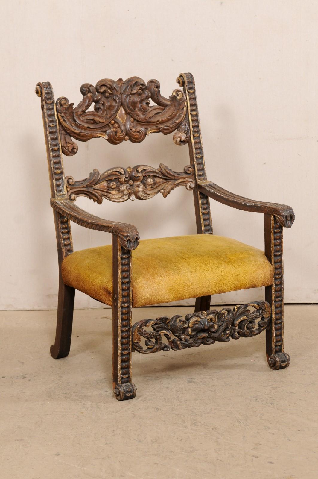 An Italian carved-wood Baroque armchair from the 18th century, possibly older. This antique chair from Italy has meticulous hand-carvings throughout, with particular emphasis along it's back-splat rests and front stretcher in an acanthus leaf motif.