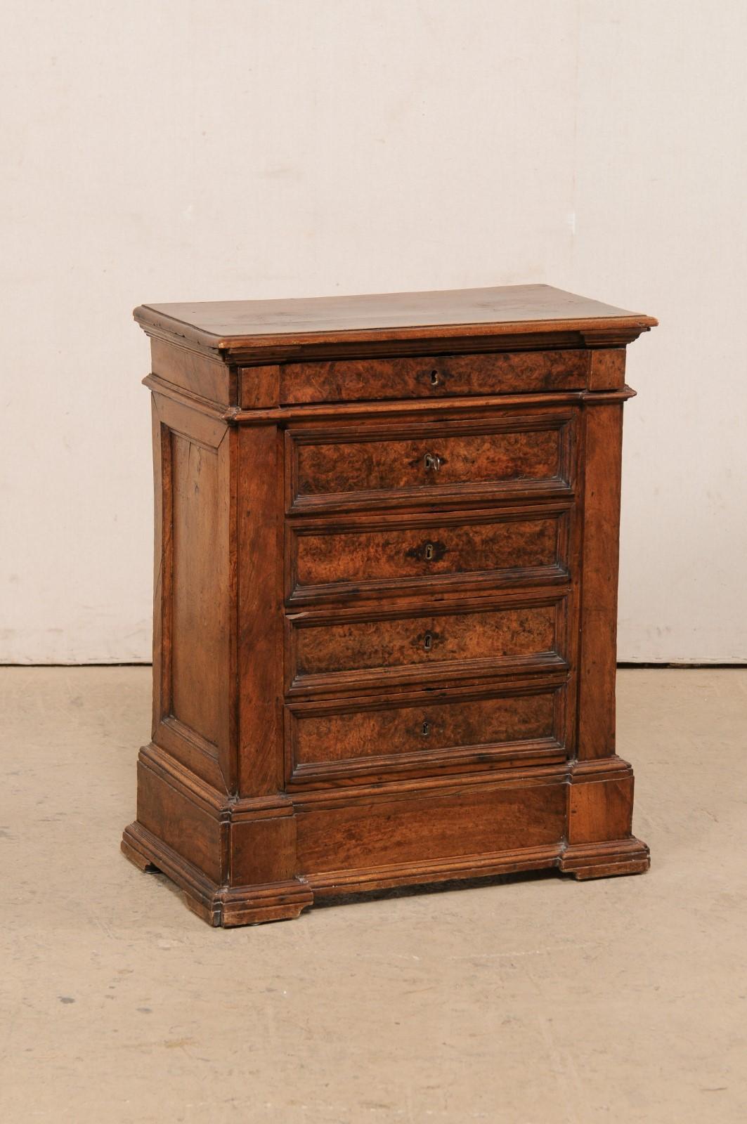 An Italian small-sized walnut chest with burl veneers from the 19th century. This antique commode from Italy has been made of walnut wood with beautiful burl wood veneers adorning the drawer fronts. The rectangular-shaped top sits about a case which