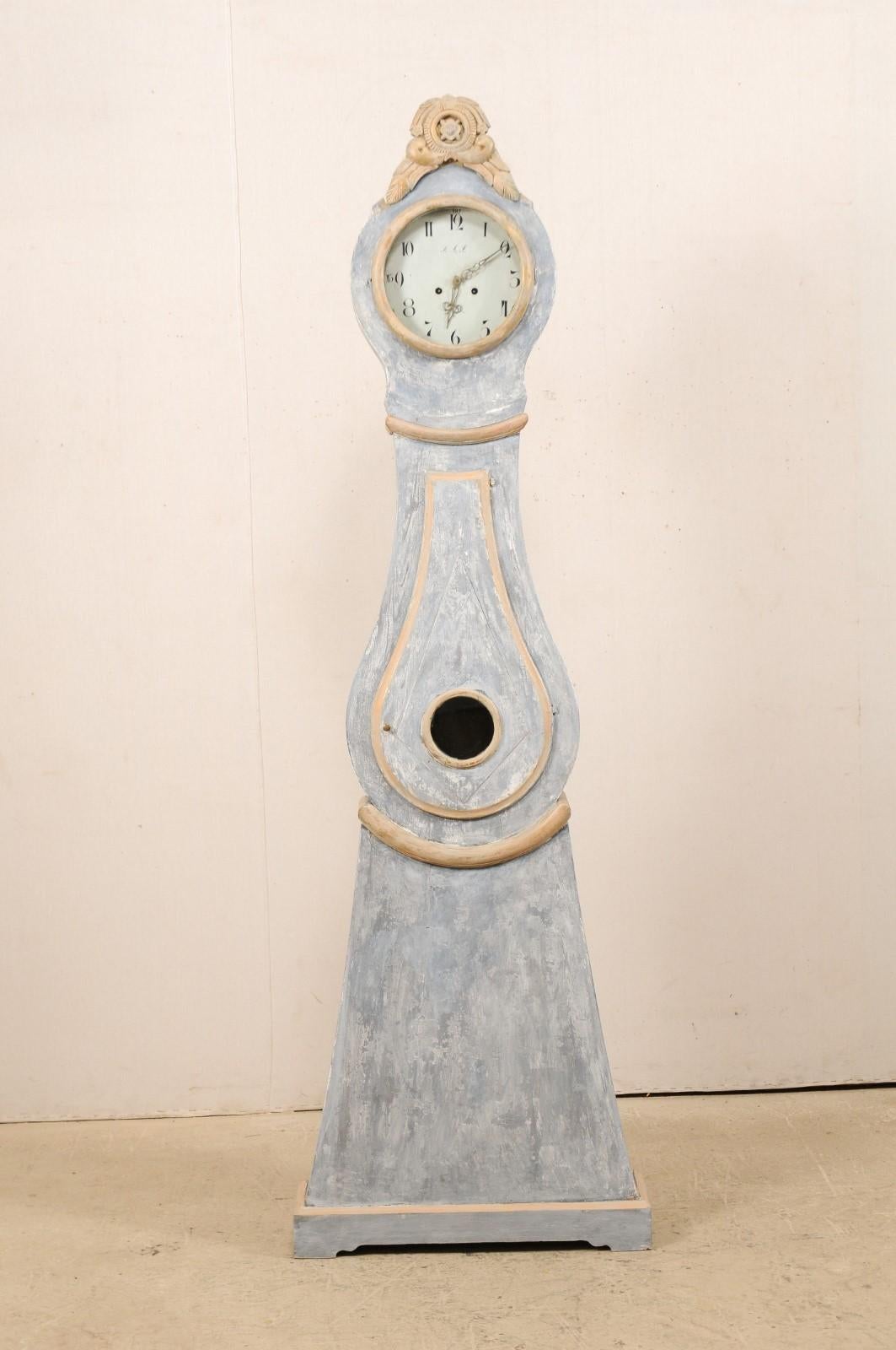 An early 19th century Northern Swedish painted wood grandfather clock with nice trimmings. This antique floor clock from Norrbotten County, Sweden (Northern region) features a nicely carved, exaggerated and raised top crest adorn with petite flower