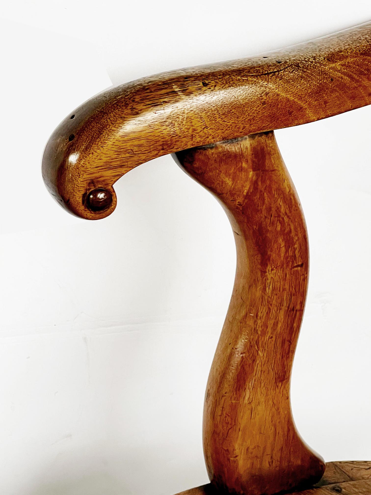 The incurved backrest above a pierced vasi-form splat; above a serpentine seat all raised on turned legs joined by a turned stretcher.