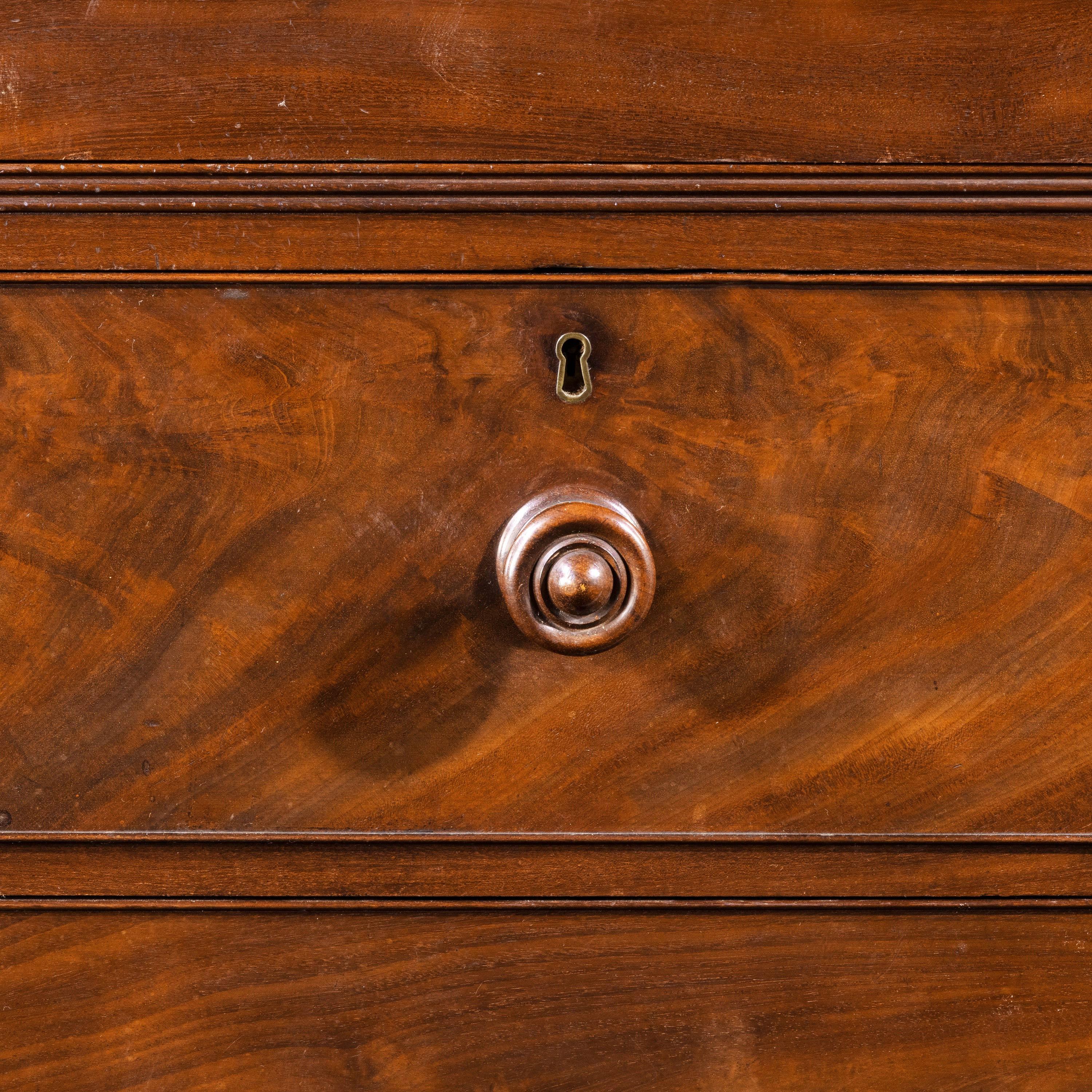 A handsome George III period breakfront wardrobe. The centre section retaining the original sliding trays. With both left and right hand hanging sections. The central base with four drawers. Beautifully figured timbers. In excellent original