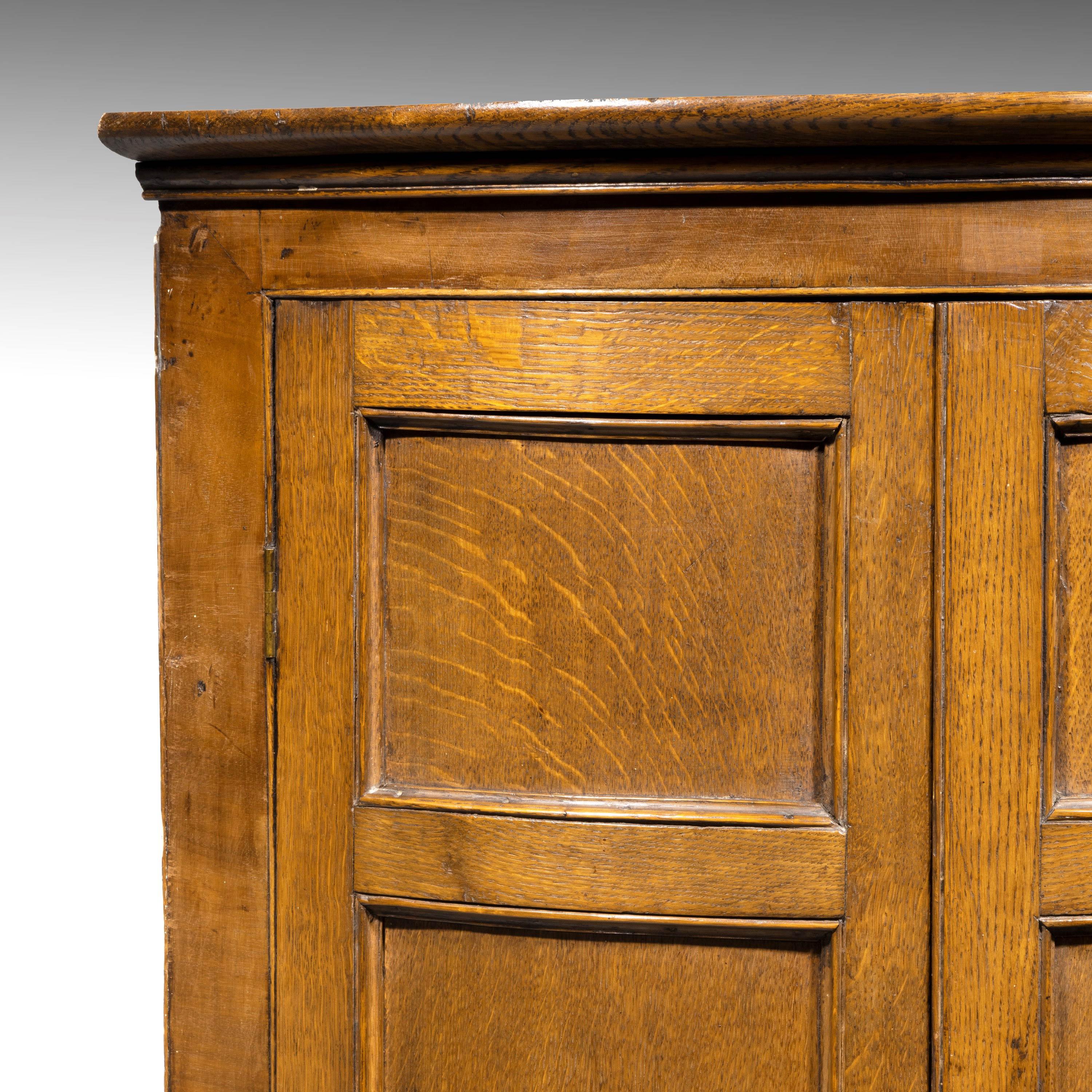 A handsome George III period oak bow-fronted corner cupboard. With recessed door sections. From a very good workshop and of quite complex construction.
   