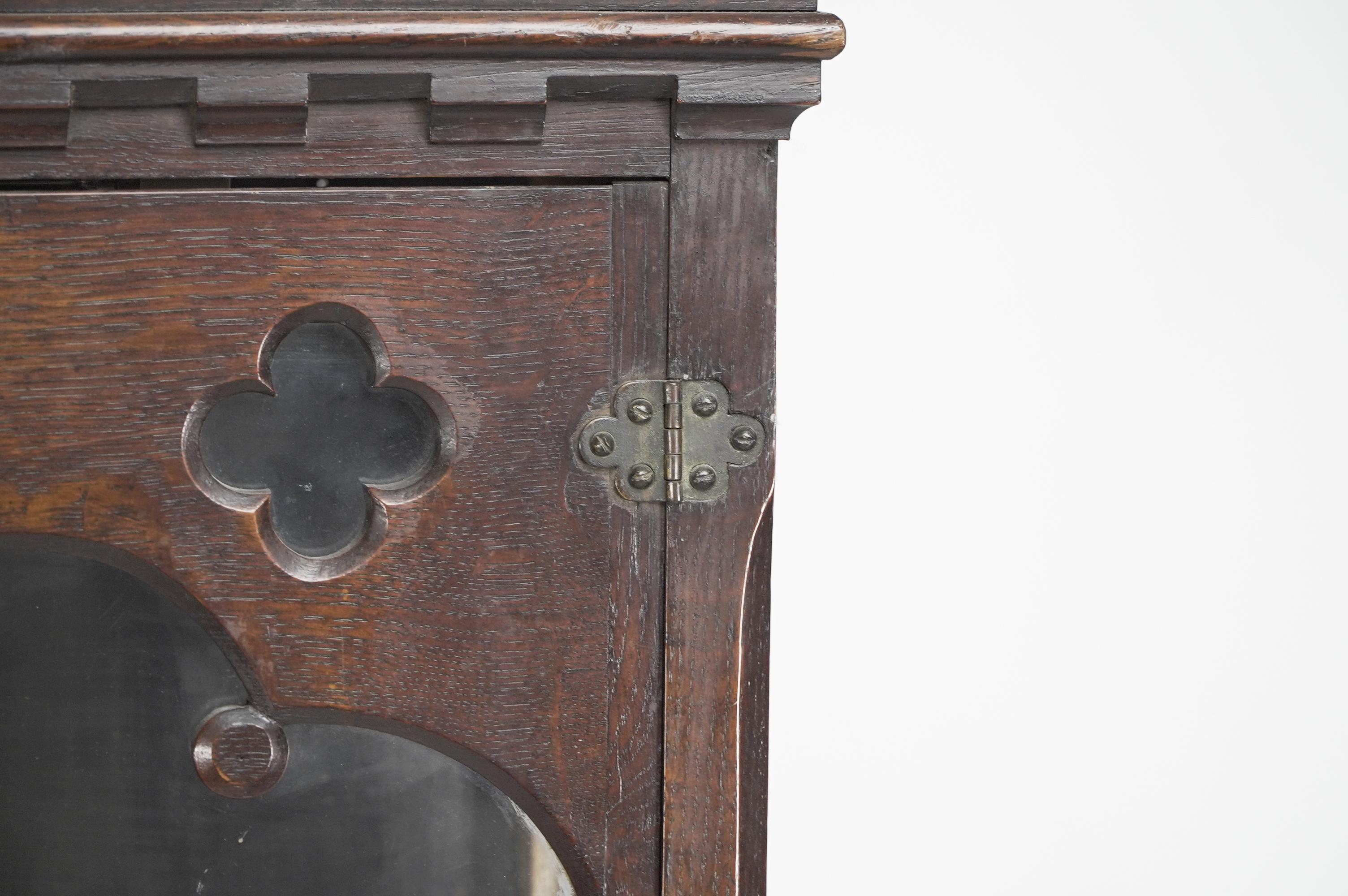 Gothic Revival oak display cabinet with arch & quatrefoil decoration on a stand. In Good Condition For Sale In London, GB