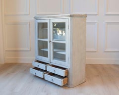 A hanging cabinet from Sweden with glass doors in grey