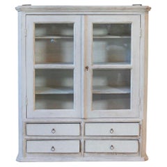 A hanging cabinet from Sweden with glass doors in grey