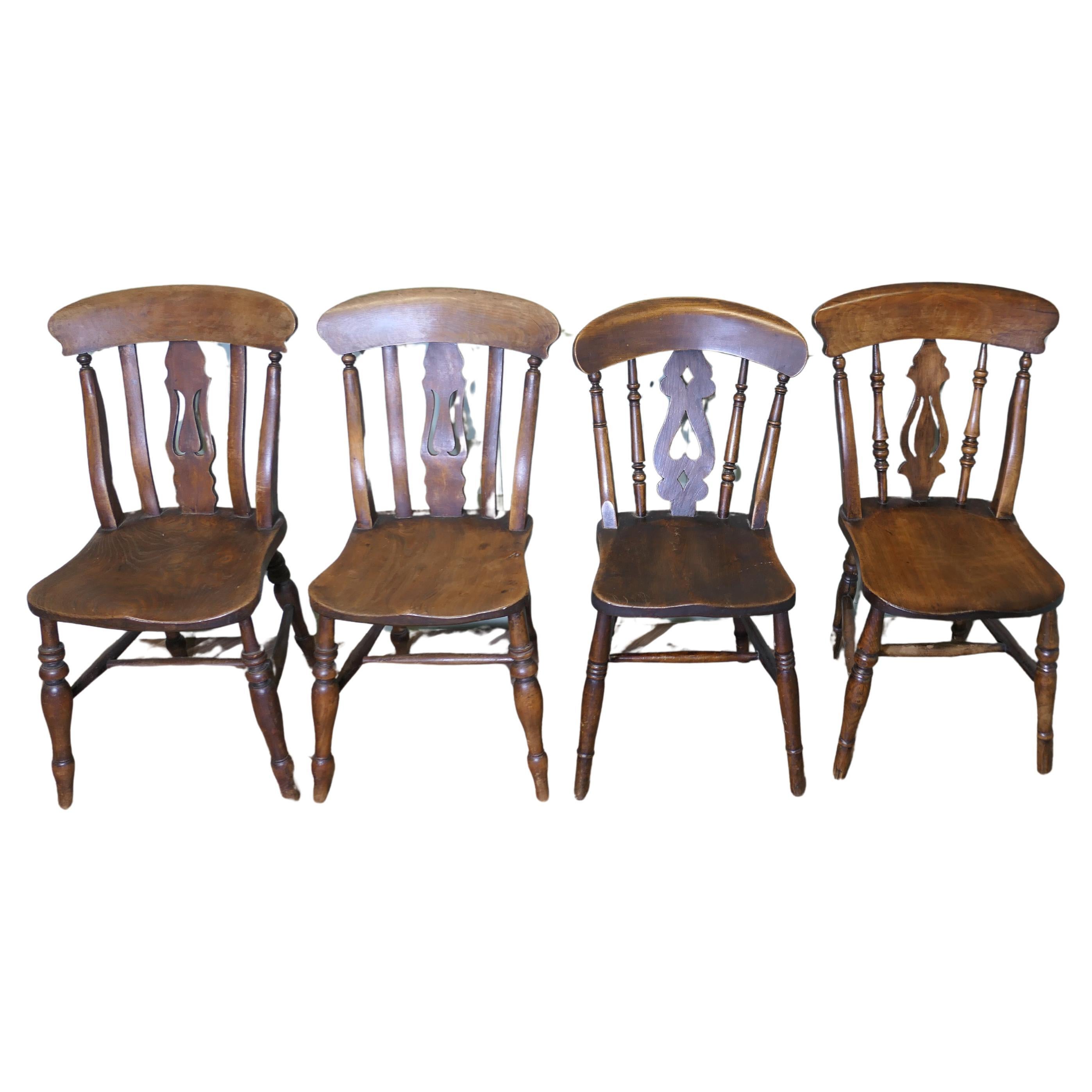 A Harlequin Set of 4 Beech & Elm Fiddle Back Chairs