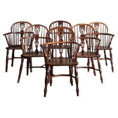 A Harlequin Set of Six Yew Wood Windsor Armchairs