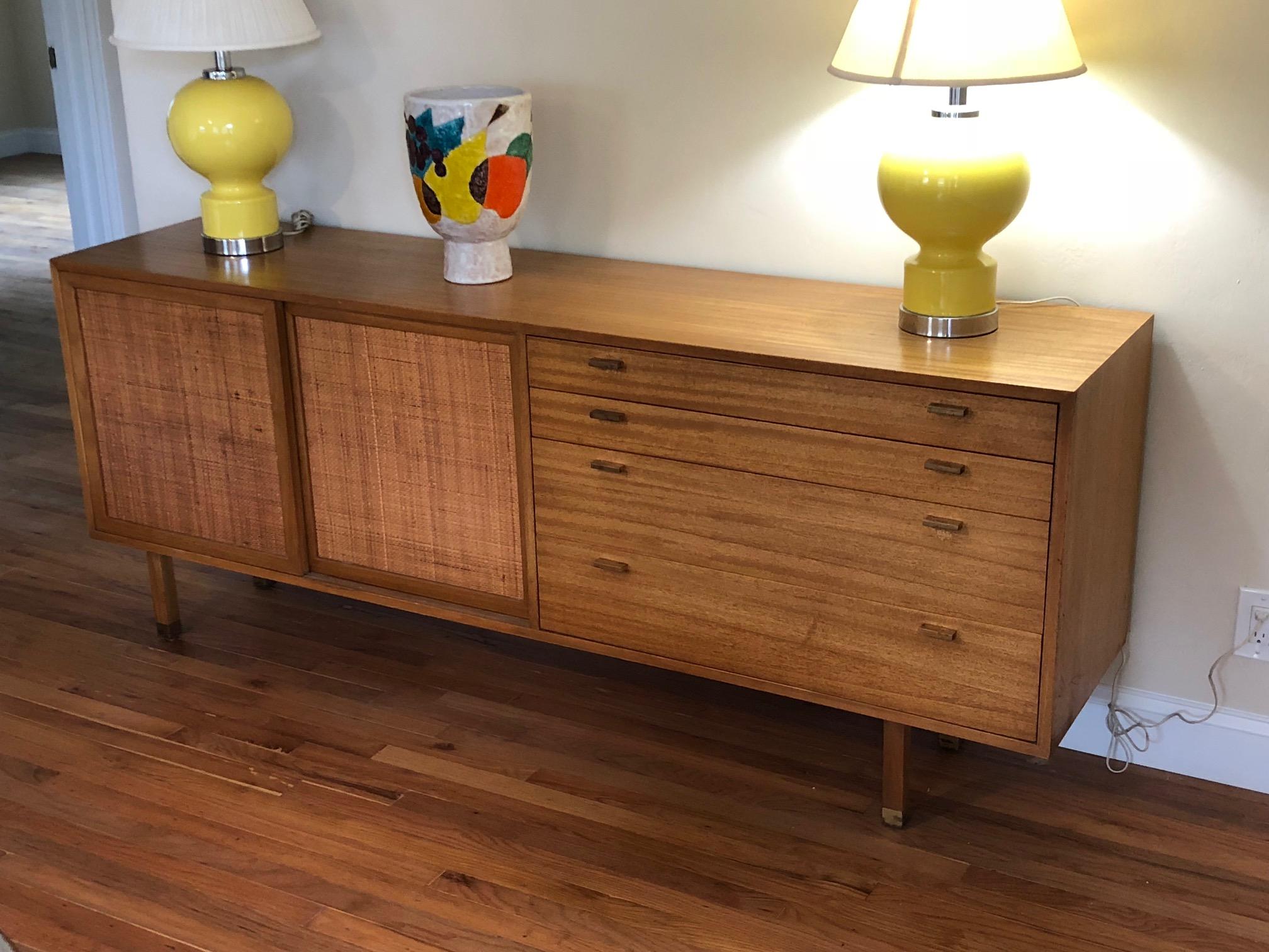 A Classic Harvey Probber mahogany credenza with caned panels and drawers. Brass sabots and cork lined drawers are just some of the details that distinguish this unusual piece.