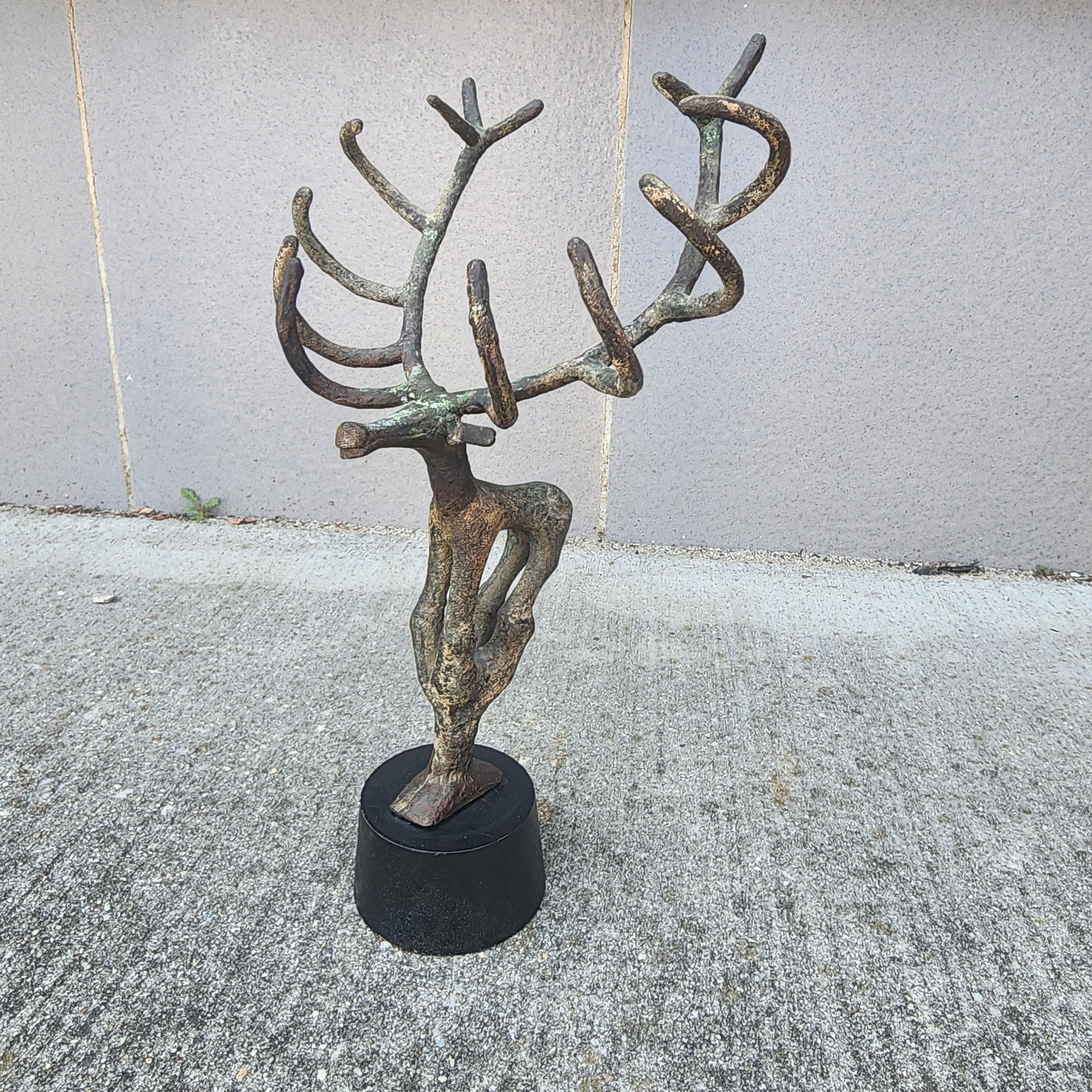 A large sculptural 1950s bronze stag in the shape of a stag. Wonderful applied patina that's further aged since it was applied. Great for a desk or to add some interest on a shelf or mantle.