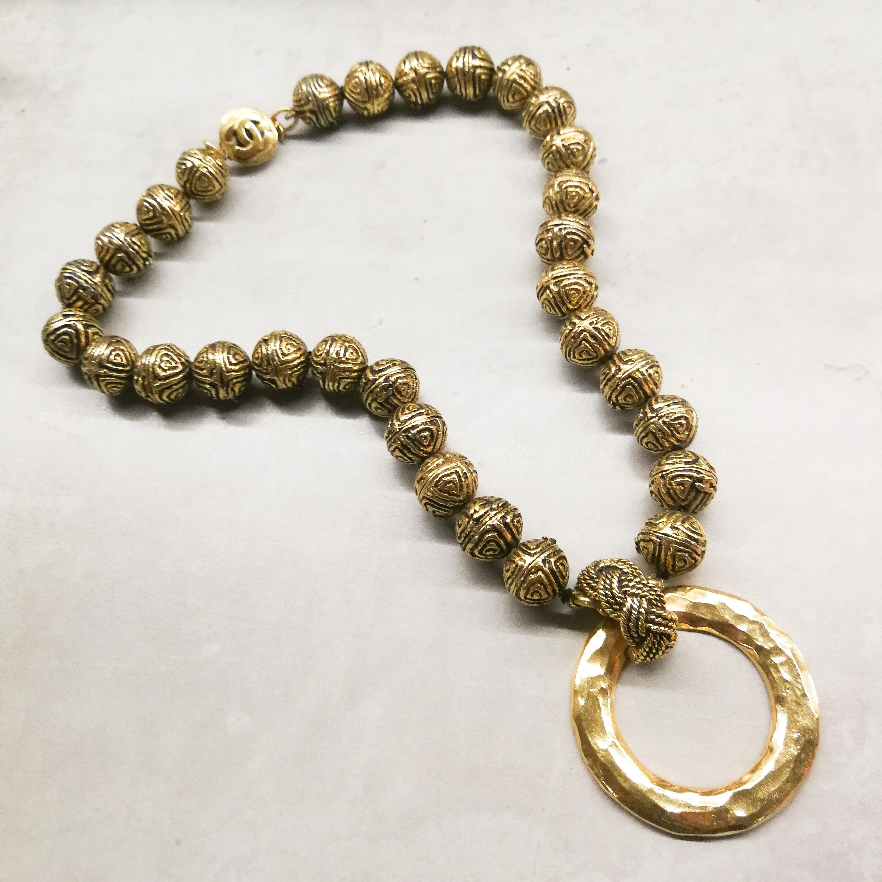 An unusual and strong necklace from the much feted and revered Chanel collections of the 1980s.  Each heavily engraved gilt sphere bears the Double C Chanel logo, subtly incorporated into the surface design, all meeting in a clear logo clasp at the