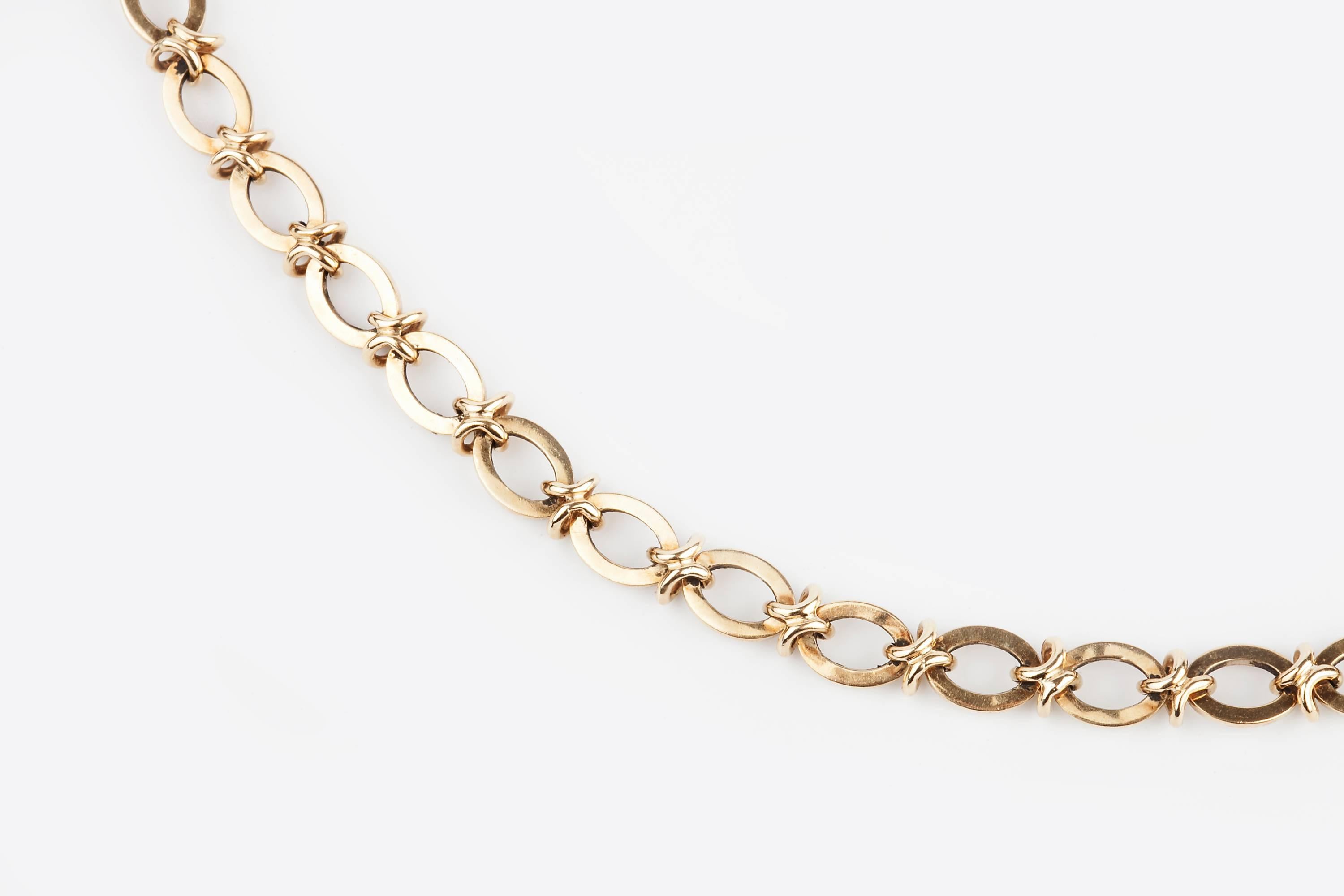 A 9ct gold chain necklace, by Cropp & Farr, composed of polished oval links with knot links between, hallmarked for London, 1994 and stamped ‘C&F’, necklace length 64.5cm, it is a wonderful necklace which would looks great as a modern longuard.