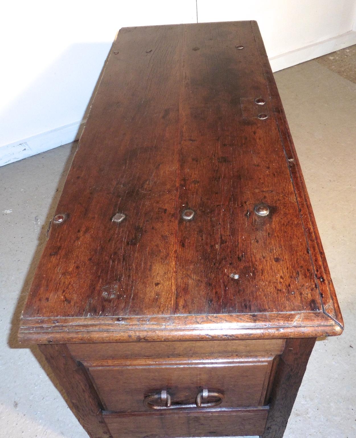 A heavy French paneled oak coffer, 1800

 The chest has 2 molded panels on the front and 1 more on each side with a carrying handle
This is a very heavy piece it is made from solid oak
The top of the box has a planked and molded edge and it has