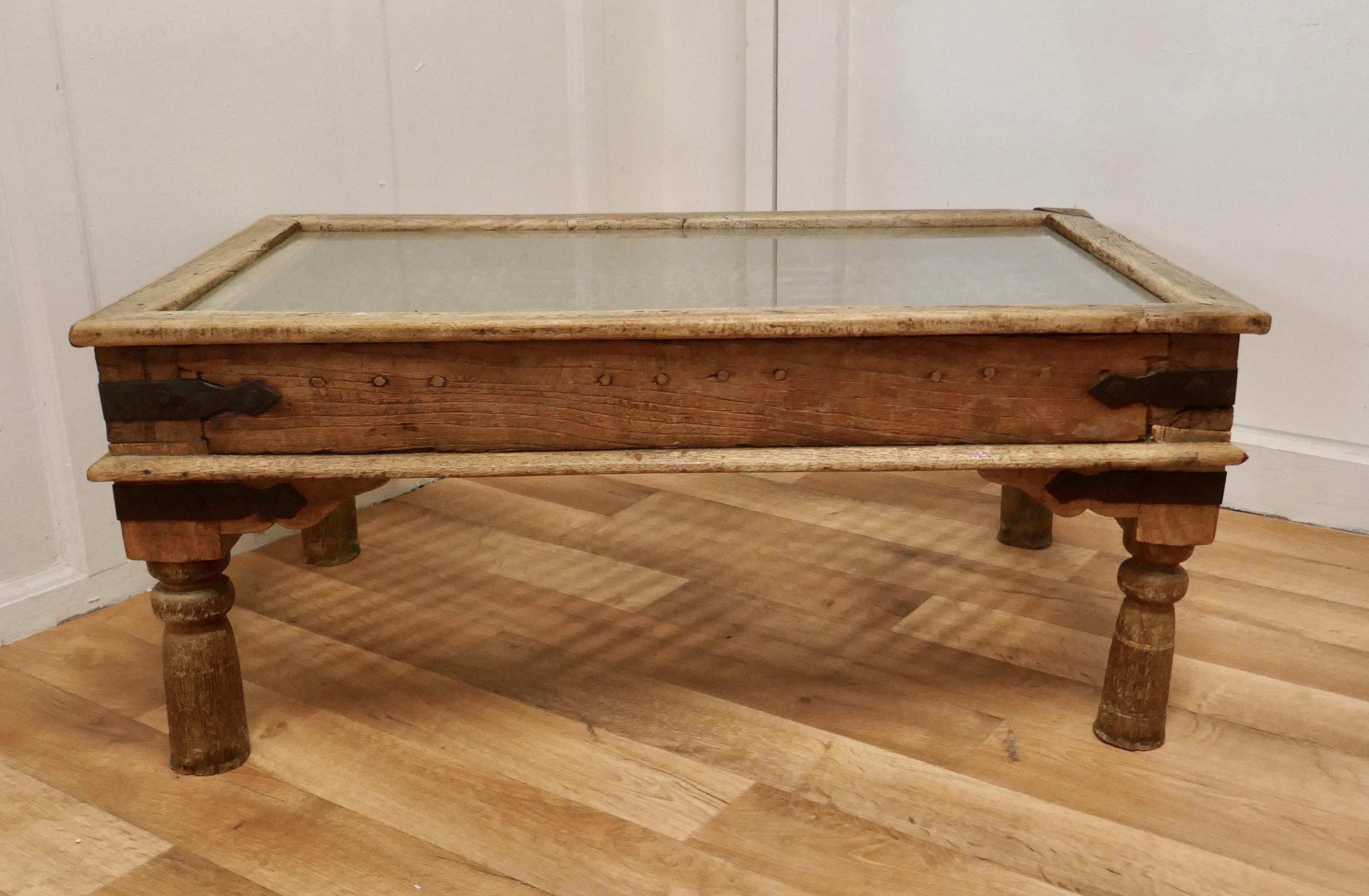 A heavy North African coffee table with inset iron grill

This is an unusual Piece made from a 19th Century Heavy Door. The table has a solid wood frame made from a door panel that has the decorative Wrought Iron security panel included in the