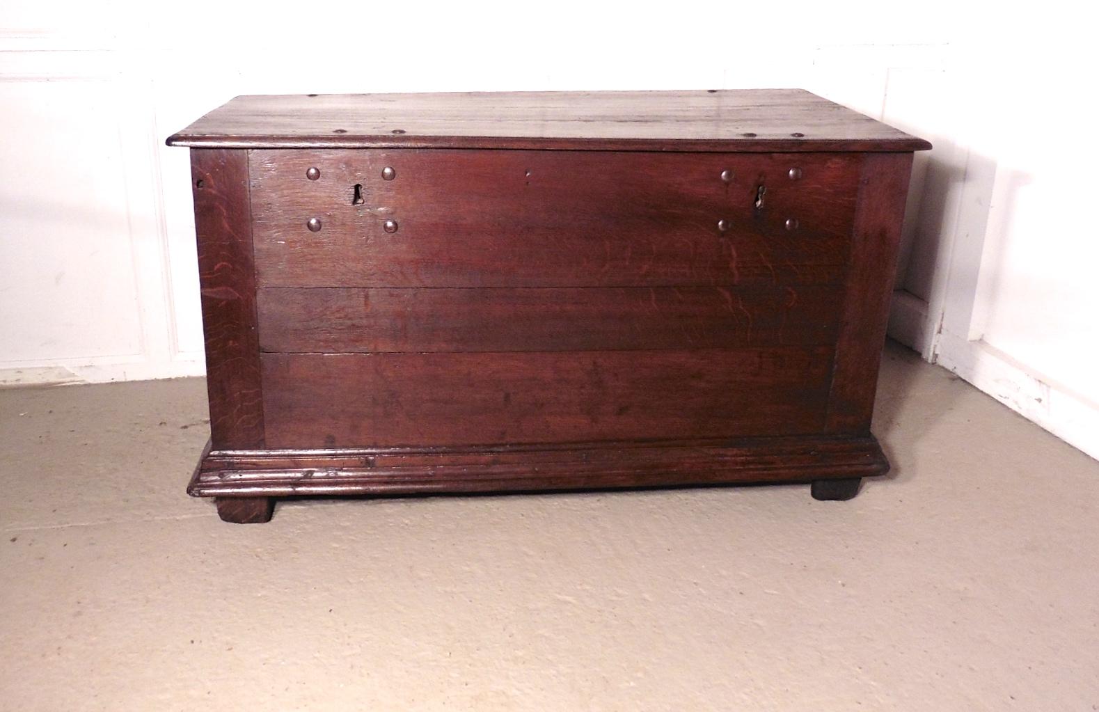 A heavy rustic oak coffer

This is a very solid and heavy piece it is made from solid oak, the chest has 2 Iron locks the front sadly we do not have the key
The top of the box is planked and has moulded edge and it has a candle box inside
This