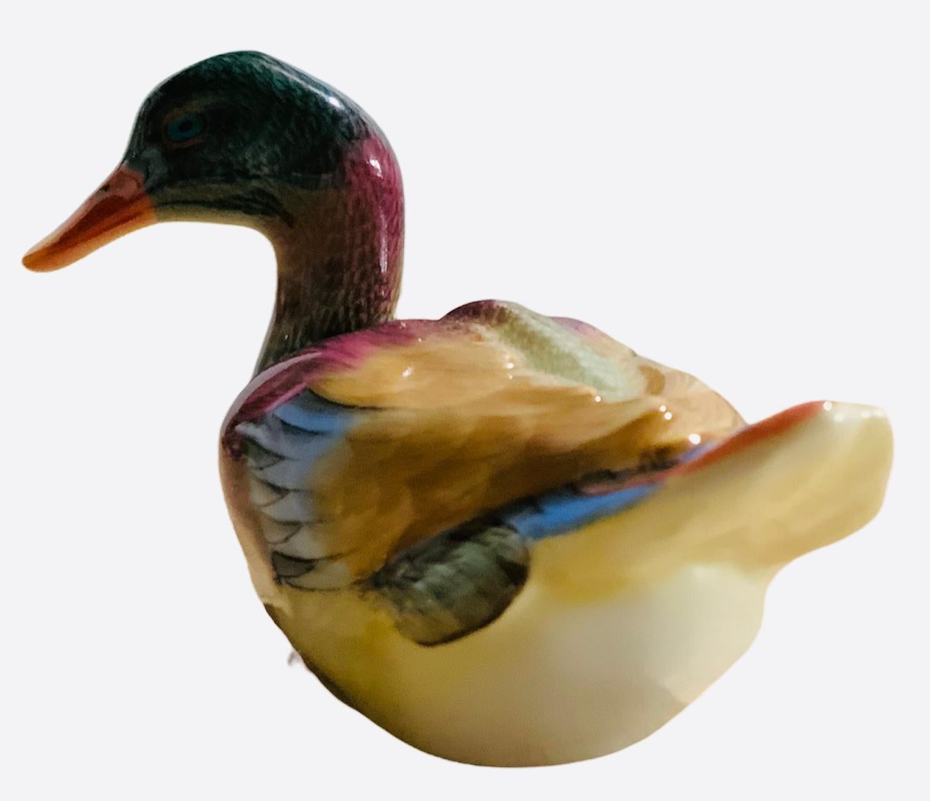 This is a Herend porcelain hand painted wild duck. It has eye catching bright colors in its whole body. The duck’s eyes are blue color. Its beak is orange-yellow as well as its feet. Below the base is the Herend hallmark.