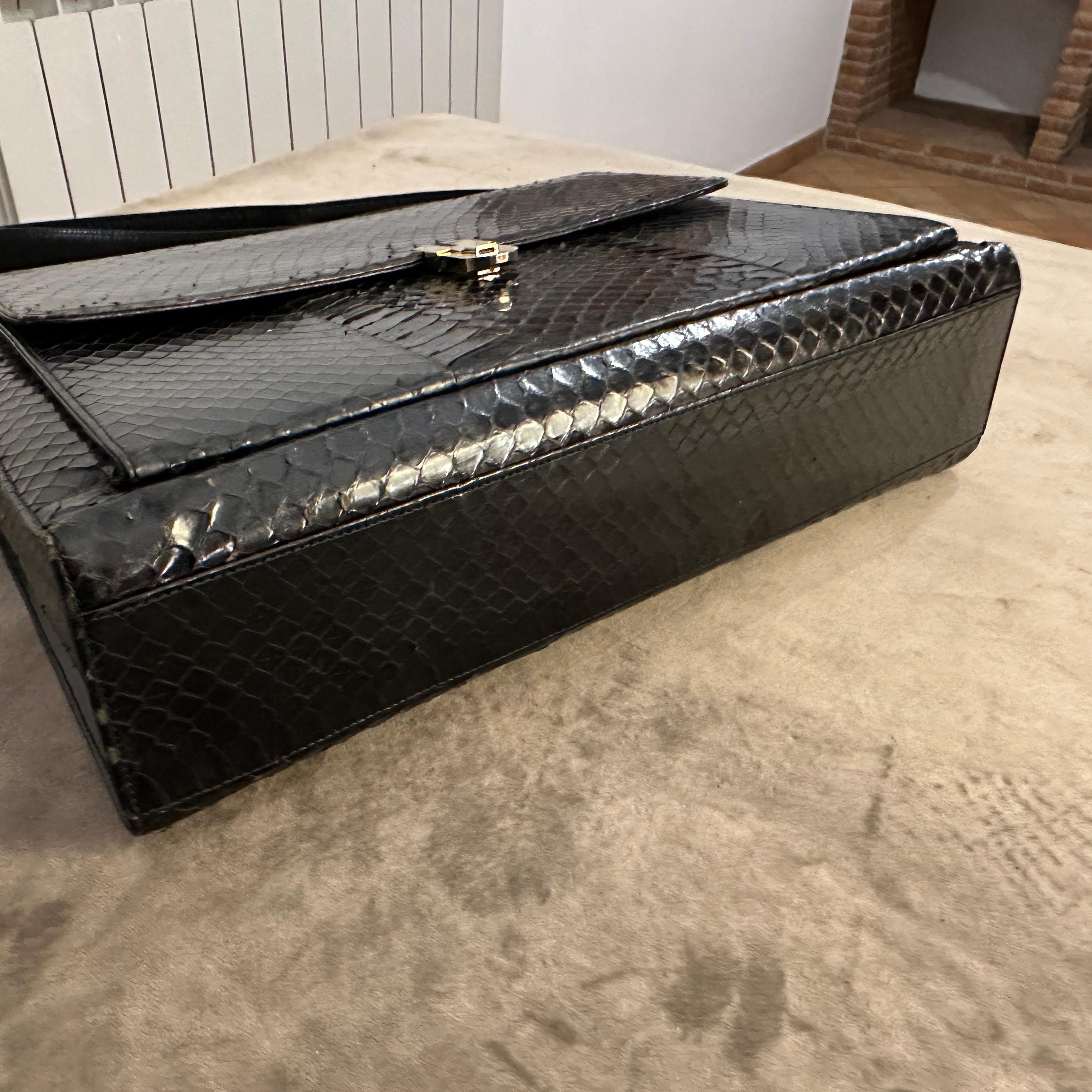 This is a high-quality vintage Italian handbag from the 1950s, crafted from rich brown leather with a distinctive snakeskin texture. The design is structured and elegant, featuring a rectangular shape with a fold-over front flap secured by a