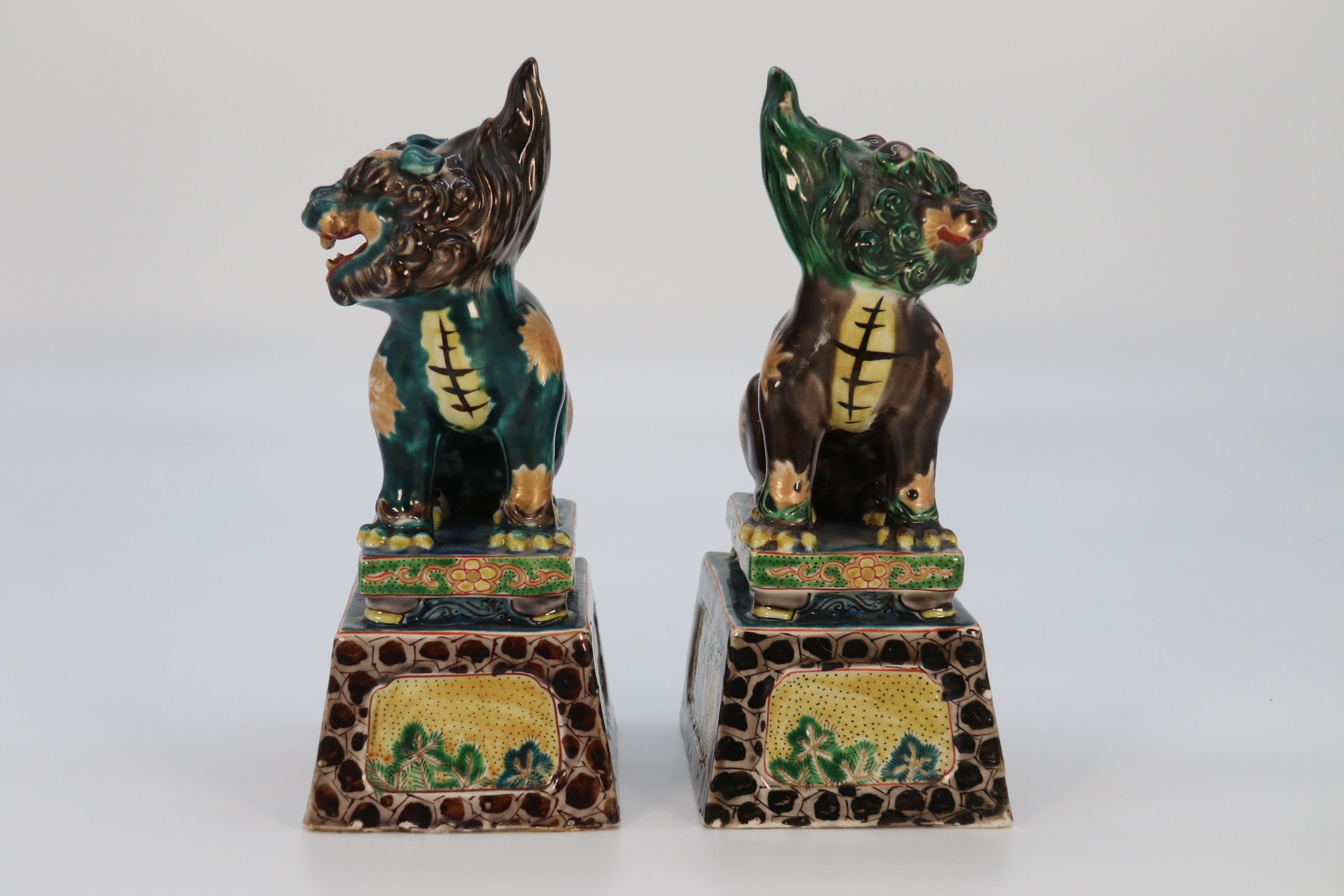 Glazed A highly decorative pair of Chinese pottery Buddhist lions circa 1900. For Sale