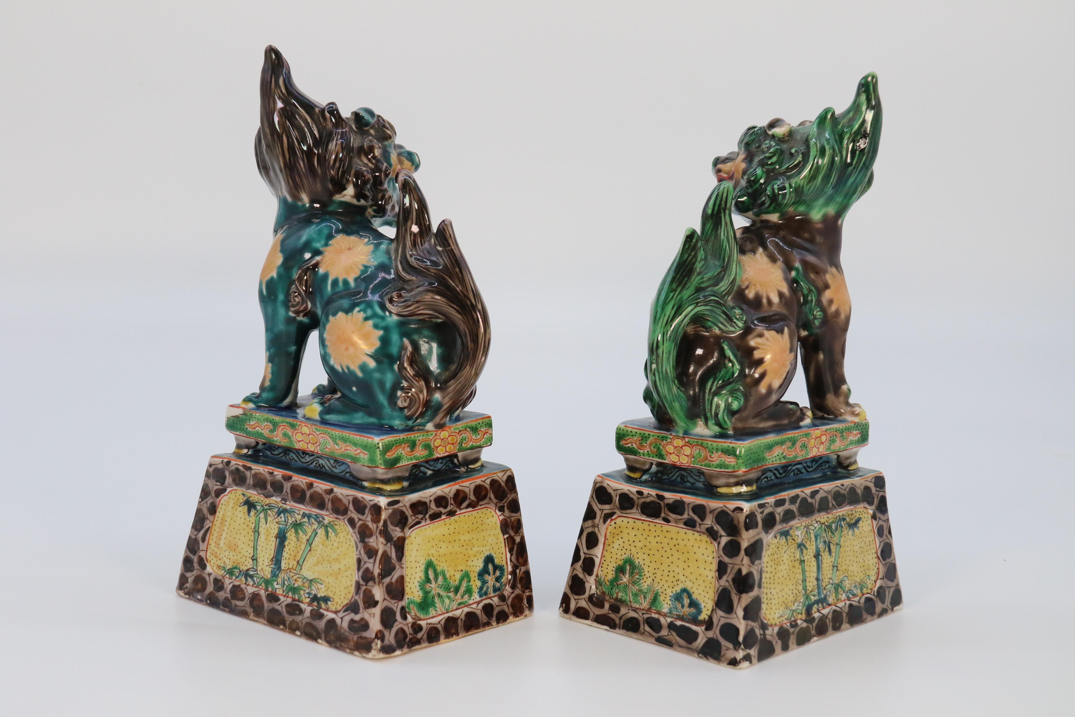 Pottery A highly decorative pair of Chinese pottery Buddhist lions circa 1900. For Sale