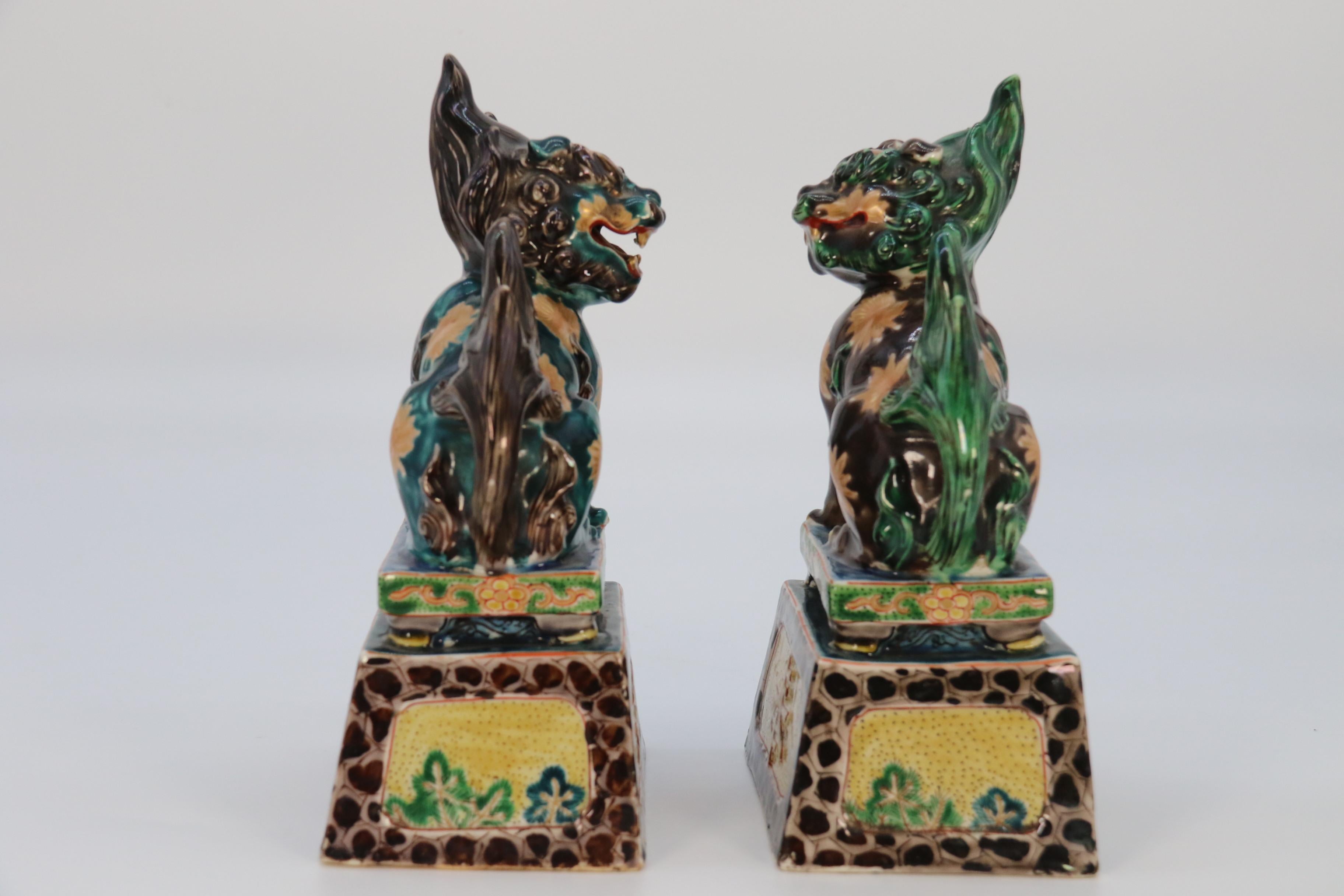 A highly decorative pair of Chinese pottery Buddhist lions circa 1900. For Sale 1