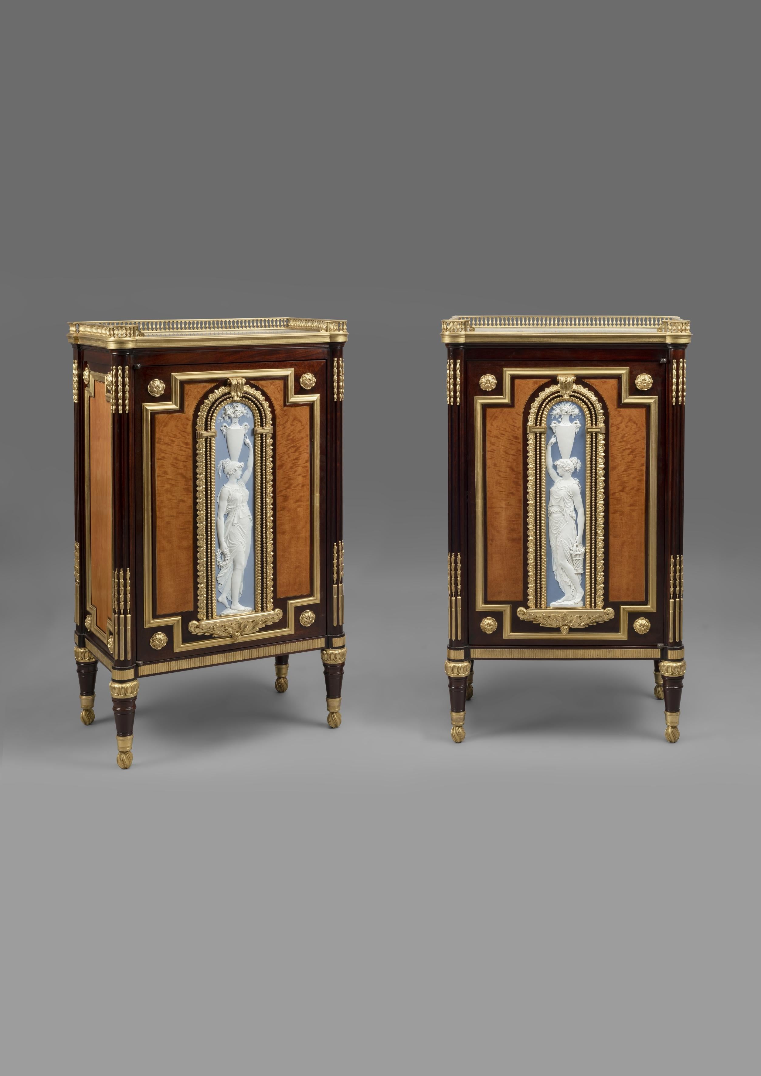 A rare and highly important pair of neoclassical style gilt-bronze and biscuit porcelain mounted mahogany side cabinets, by Jules Piret.

French, circa 1860 incorporating 18th century elements. 
The porcelain plaques late 18th century.

Stamped