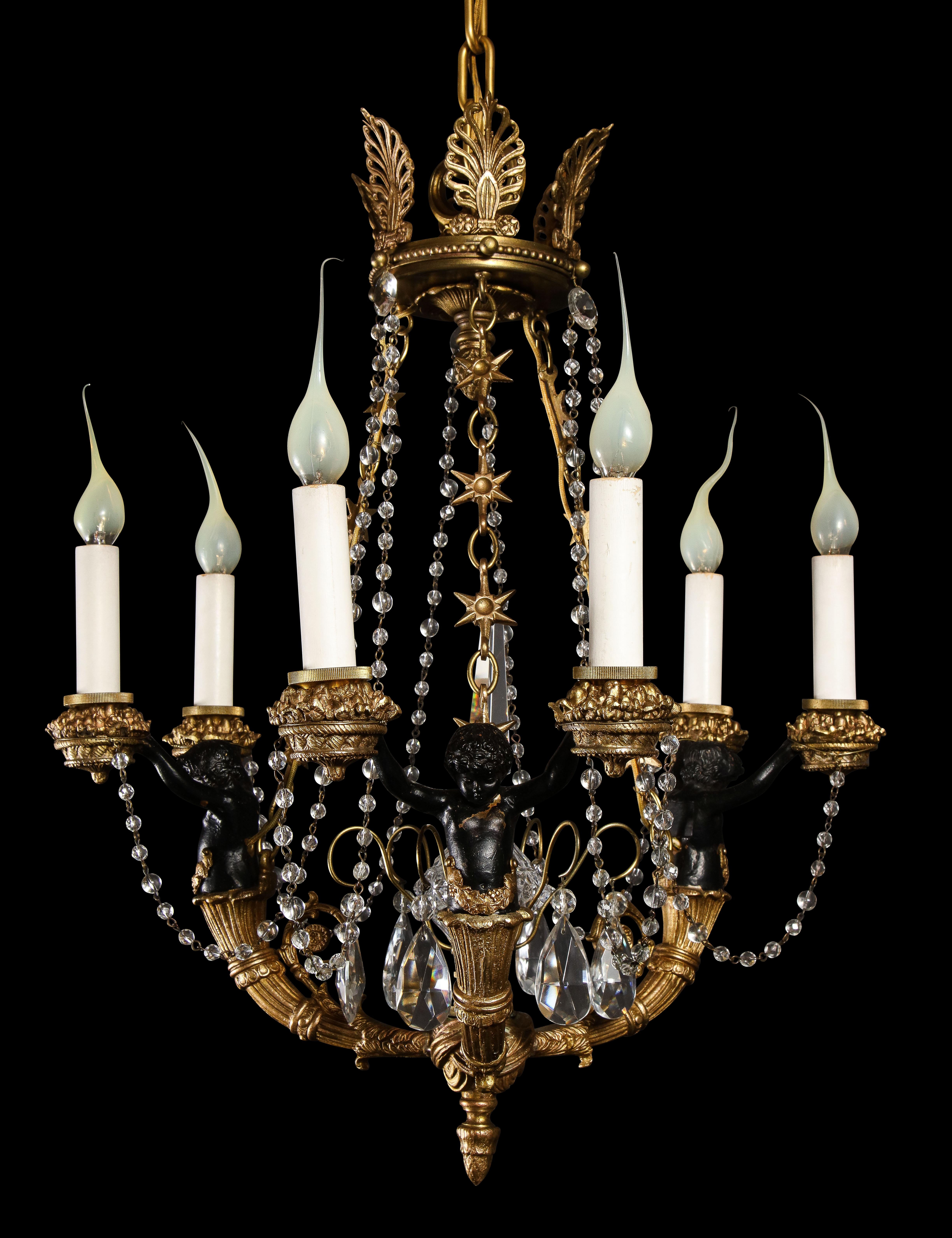 A Hollywood Regency style gilt bronze, patina bronze and glass multi light figural chandelier.