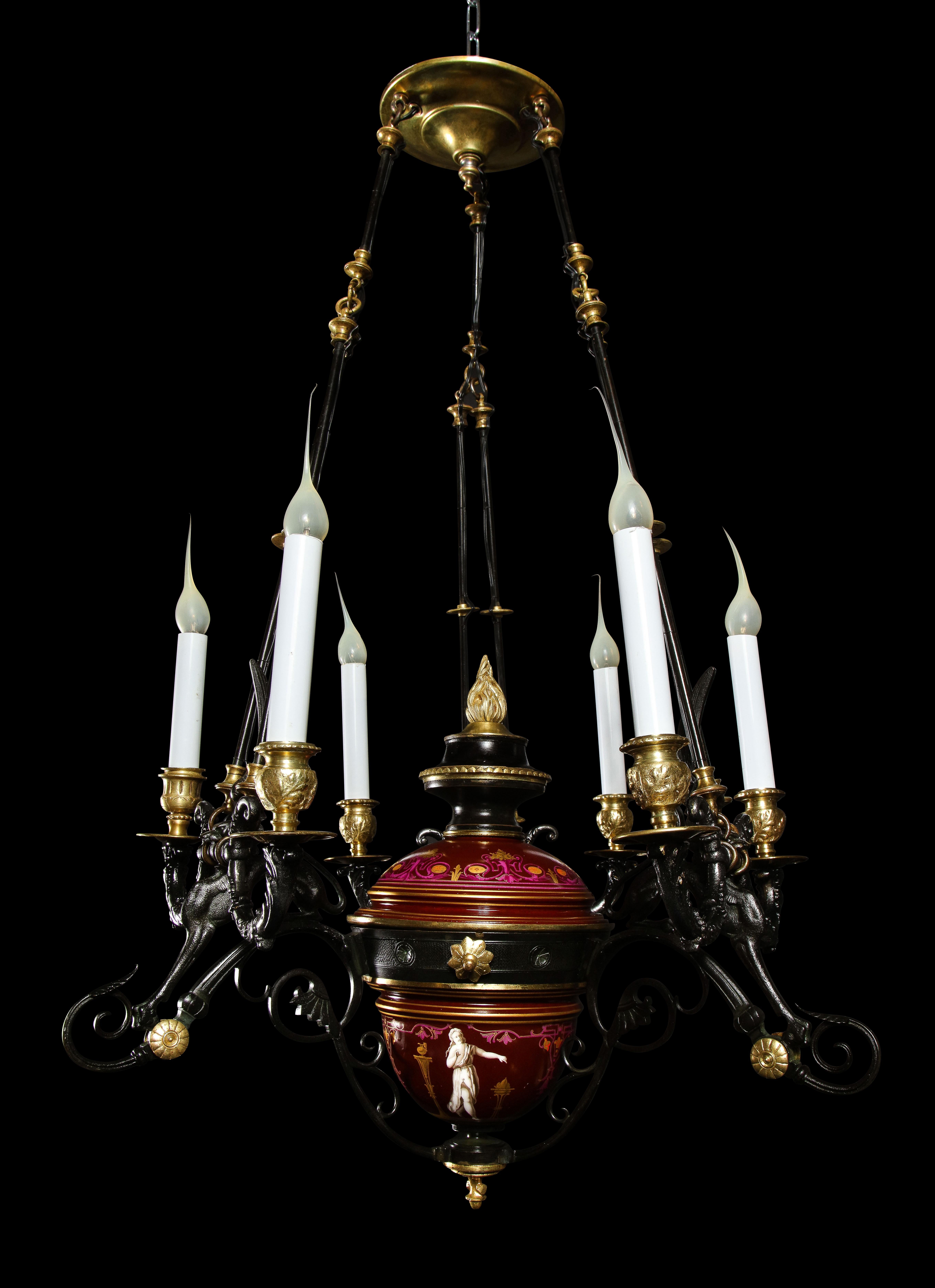 A Hollywood Regency style gilt bronze, patinated bronze and burgundy porcelain multi light chandelier.
